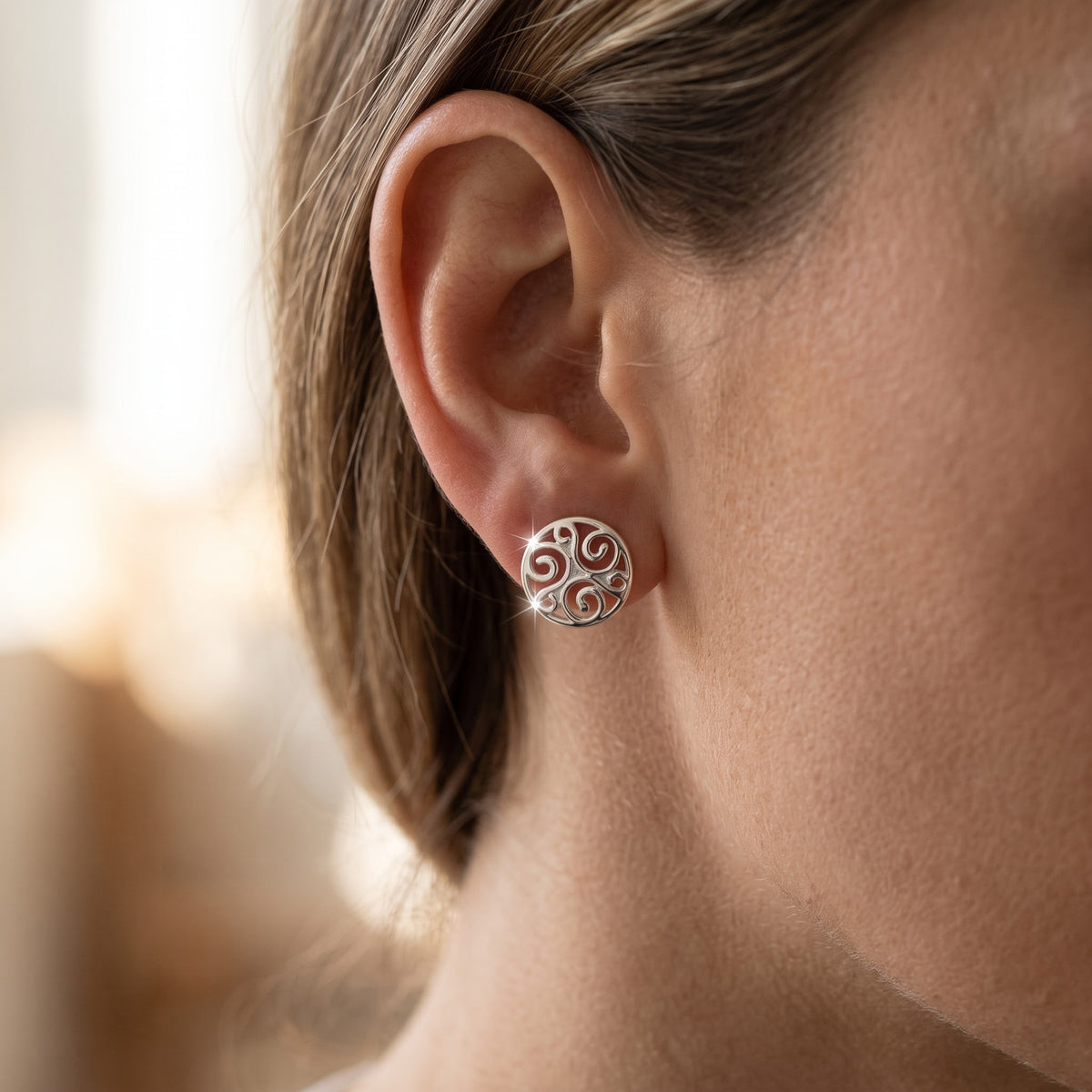 Sterling Silver Celtic Triskelion Stud Earrings - 8mm worn, lifestyle photo