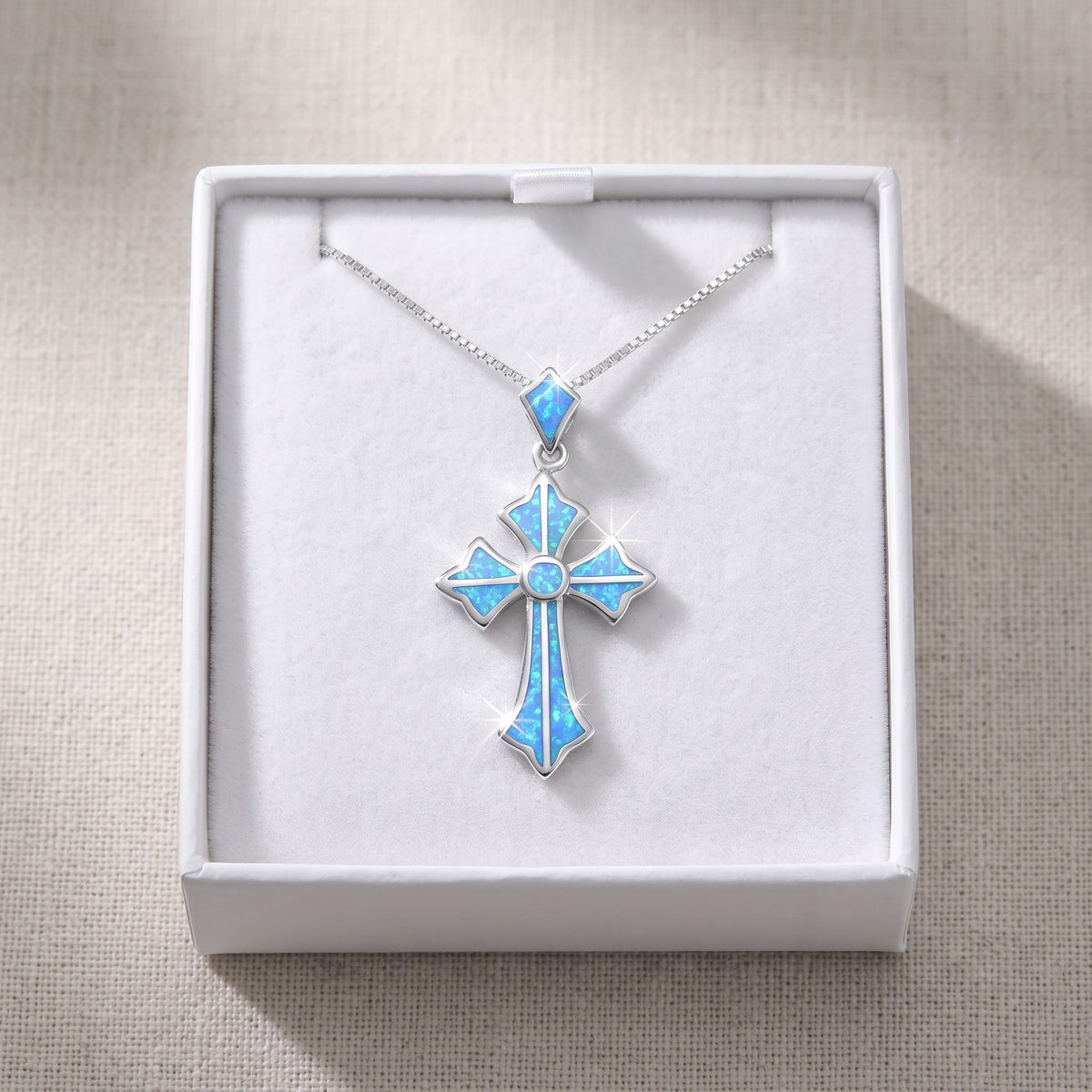 Sterling Silver Created Blue Opal Cross Necklace, 18 Inch Chain in a white gift box, ready to give
