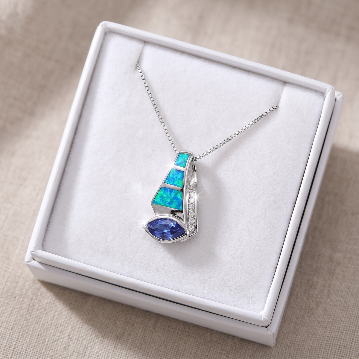 Sterling Silver Created Blue Opal CZ Drop Necklace in a white gift box, ready to give