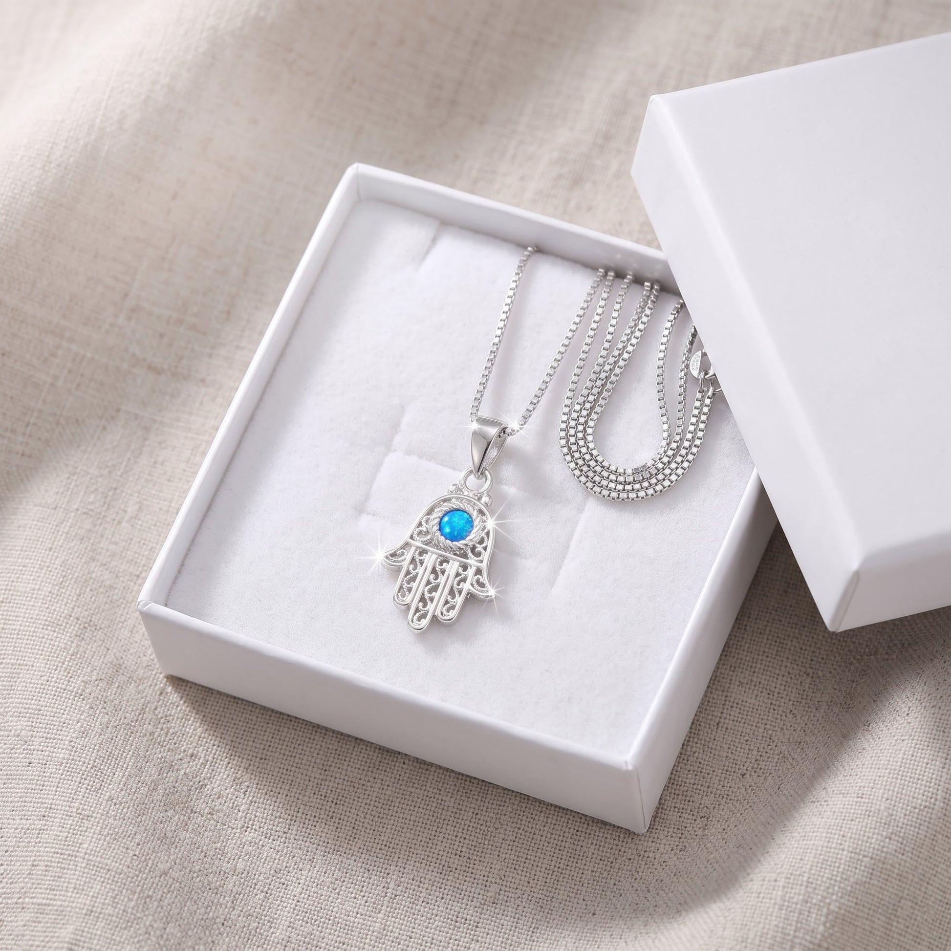 Sterling Silver Created Blue Opal Evil Eye Hamsa Necklace, 18" in a white gift box, ready to give