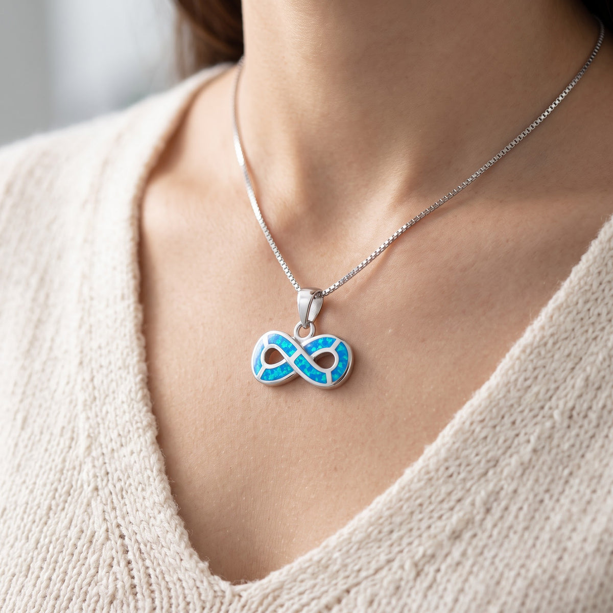 Sterling Silver Created Blue Opal Infinity Necklace worn, lifestyle photo