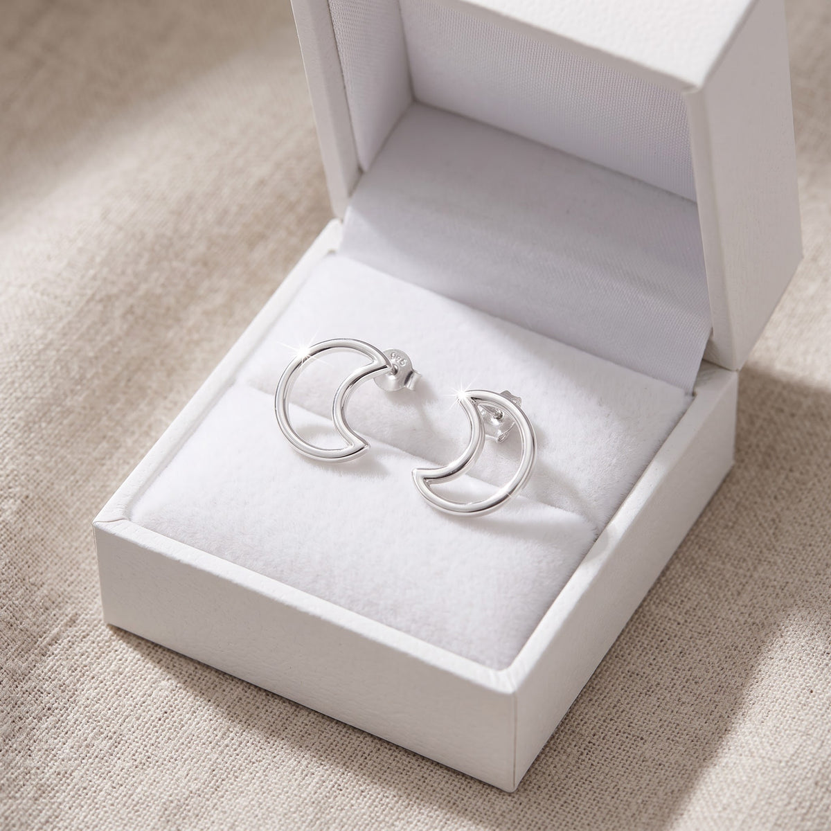 Sterling Silver Crescent Moon Stud Earrings in a white gift box, ready to give
