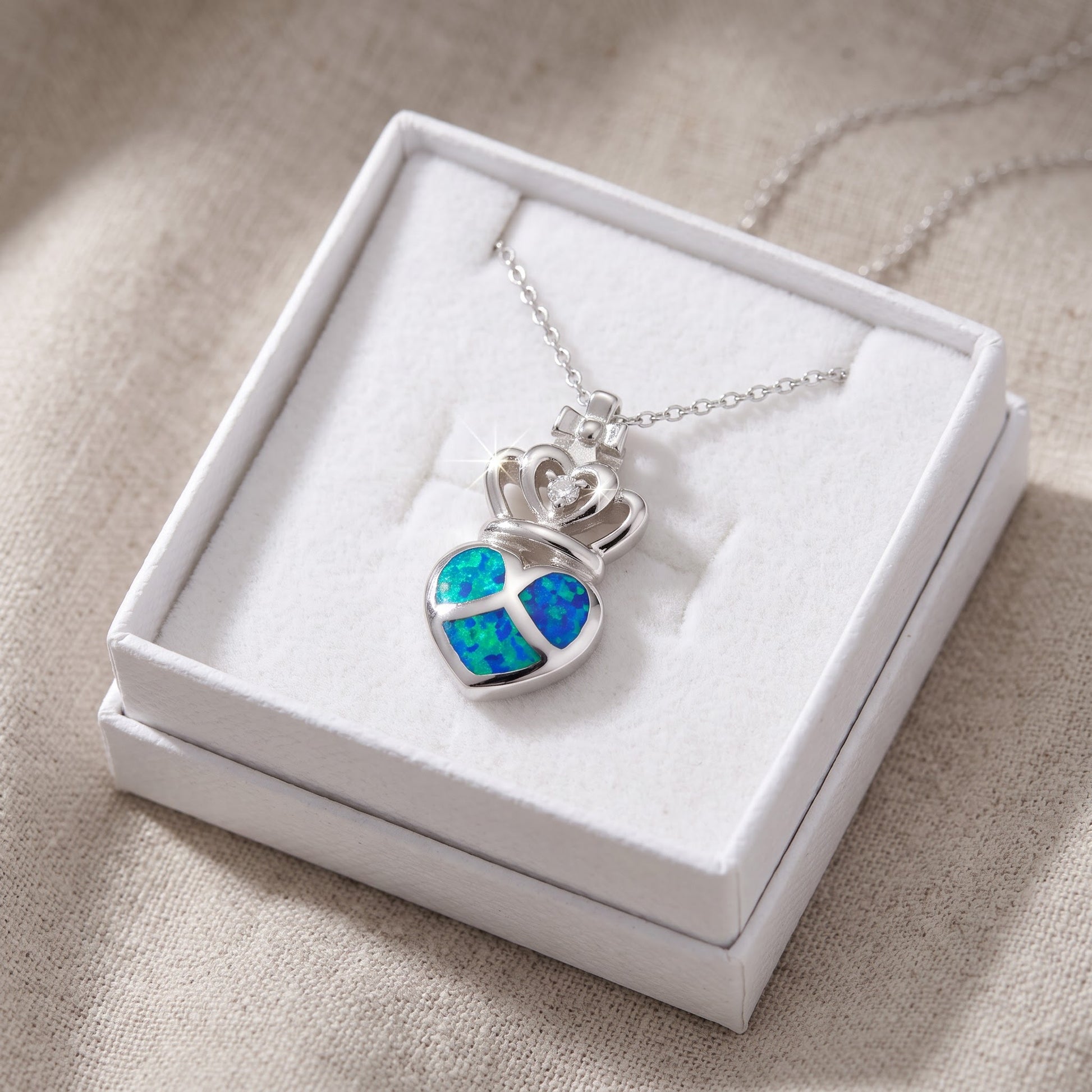 Sterling Silver CZ Created Blue Opal Crowned Heart necklace 18" in a white gift box, ready to give