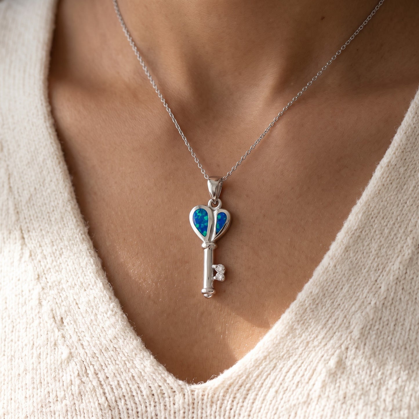 Sterling Silver CZ Created Blue Opal Heart Key necklace worn, lifestyle photo