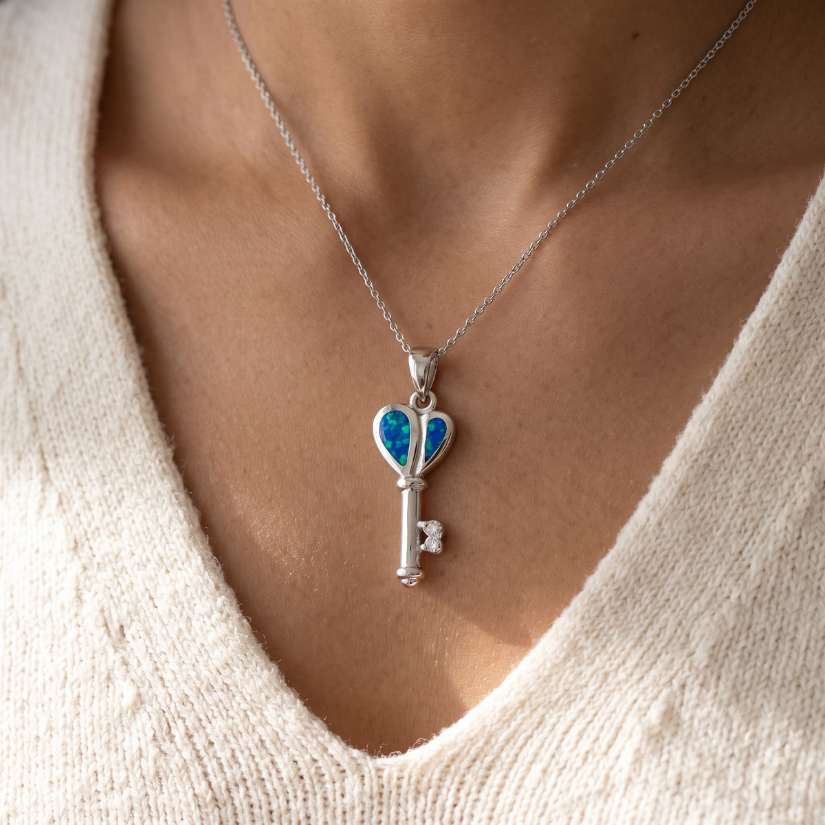 Sterling Silver CZ Created Blue Opal Heart Key necklace worn, lifestyle photo
