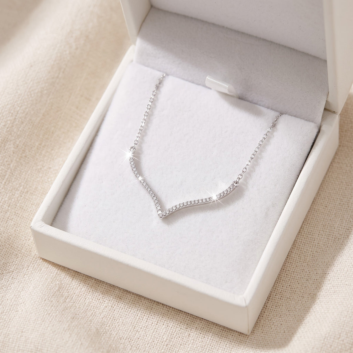Sterling Silver CZ Curved Wishbone V Necklace in a white gift box, ready to give