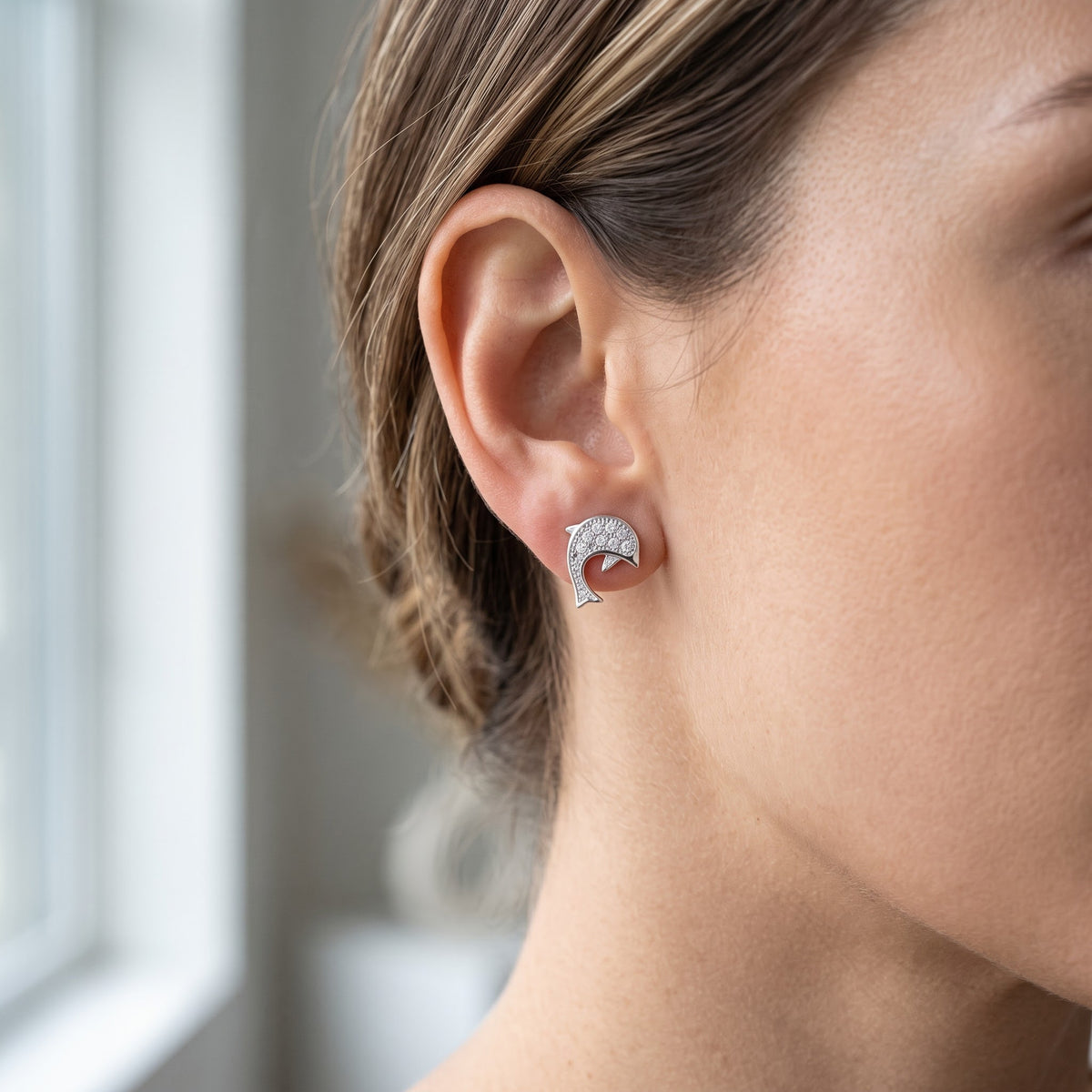 Sterling Silver CZ Dolphin Stud Earrings worn, lifestyle photo