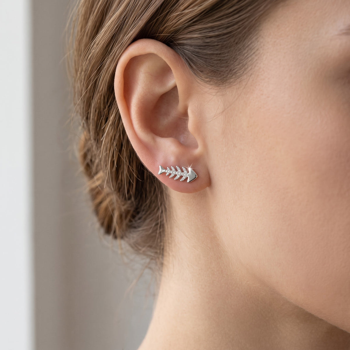 Sterling Silver CZ Fish Bone Stud Earrings worn, lifestyle photo