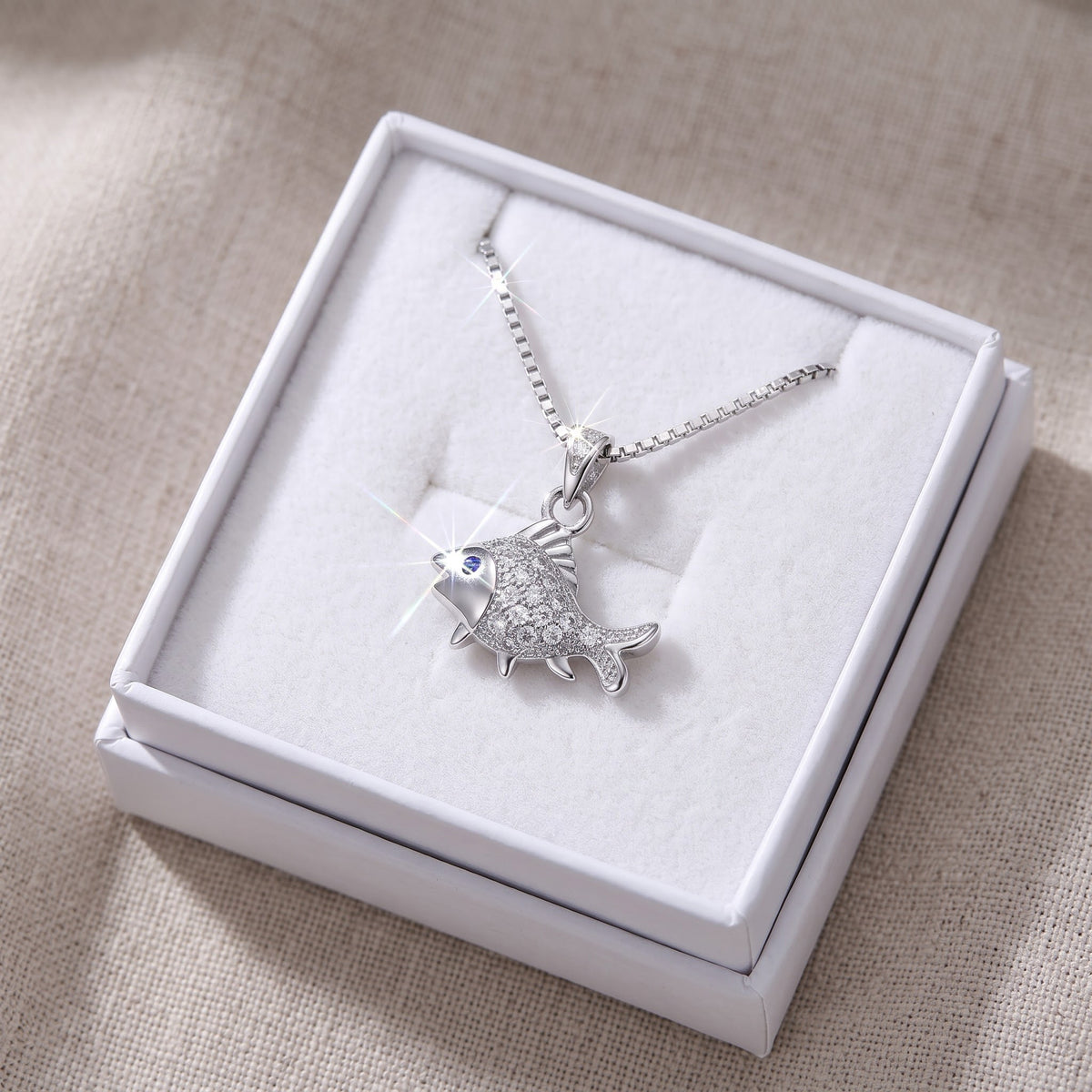 Sterling Silver CZ Fish Necklace in a white gift box, ready to give