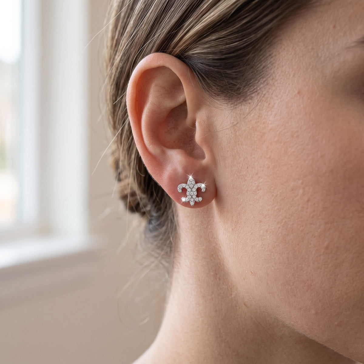 Sterling Silver CZ Fleur De Lis Stud Earrings worn, lifestyle photo