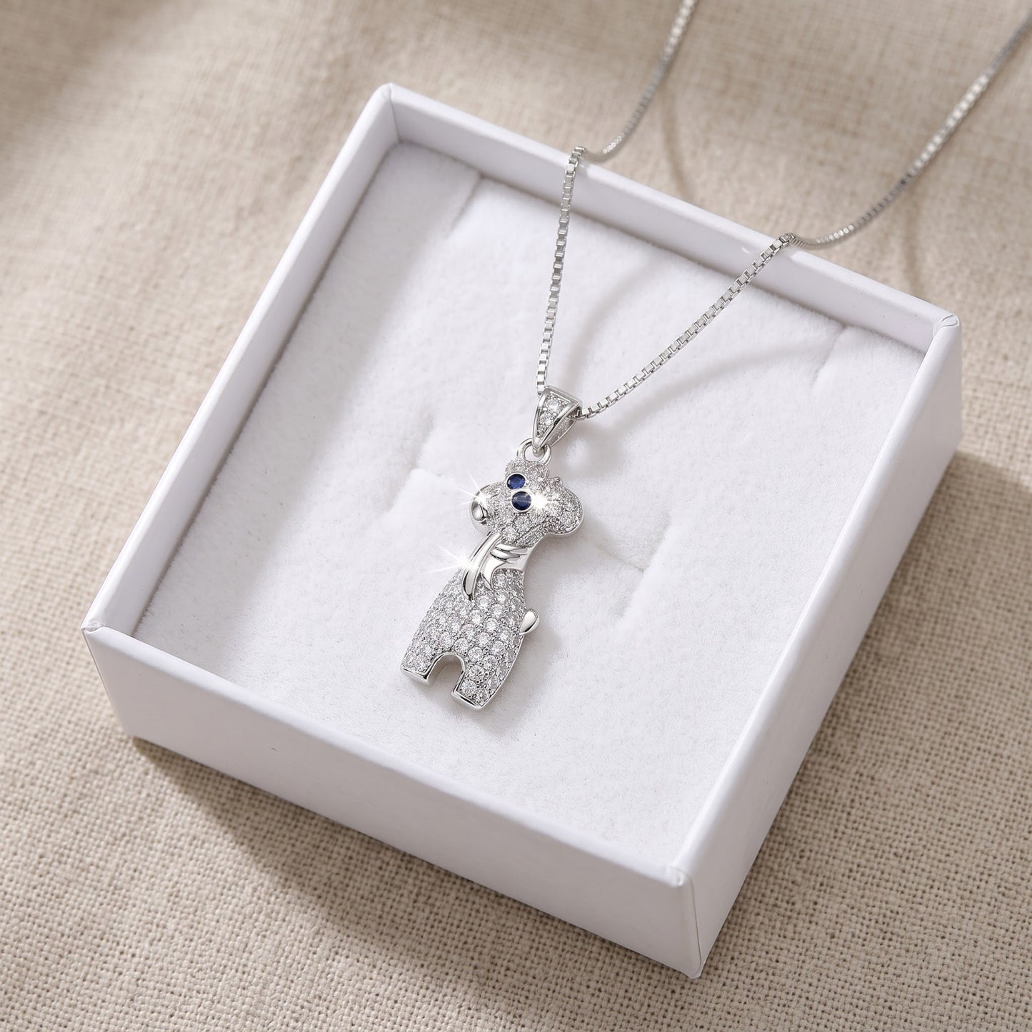 Sterling Silver CZ Giraffe Necklace in a white gift box, ready to give