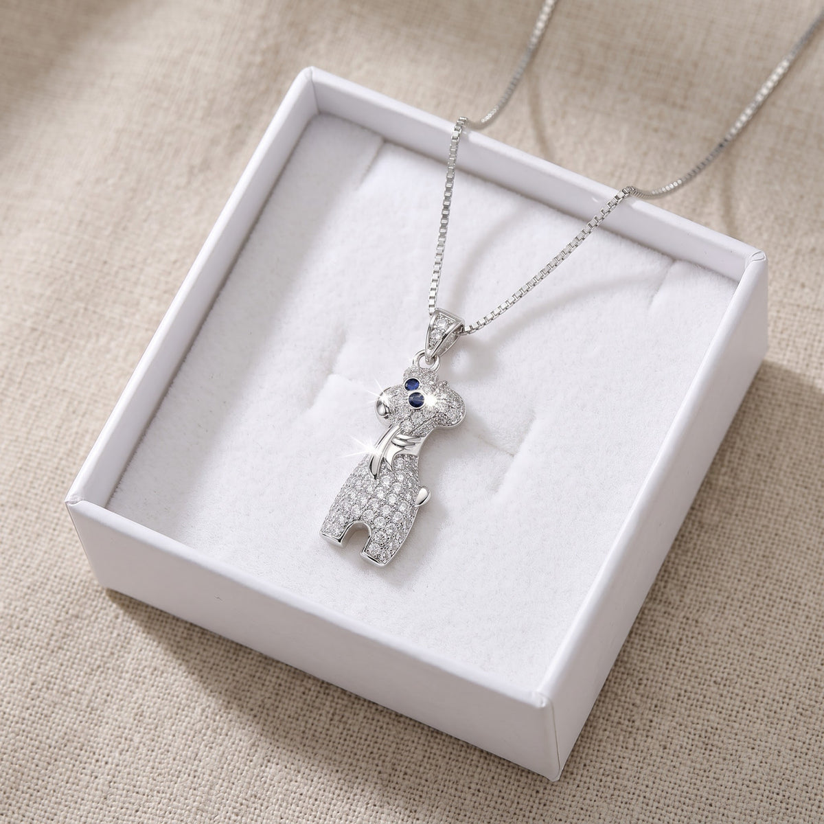 Sterling Silver CZ Giraffe Necklace in a white gift box, ready to give