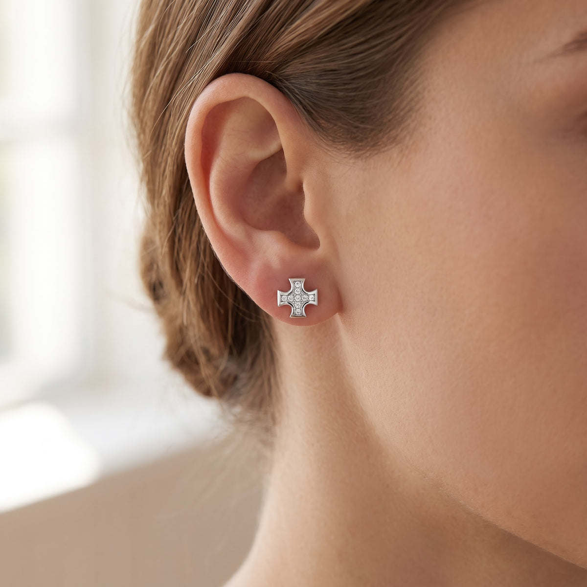 Sterling Silver CZ Iron Cross Stud Earrings worn, lifestyle photo