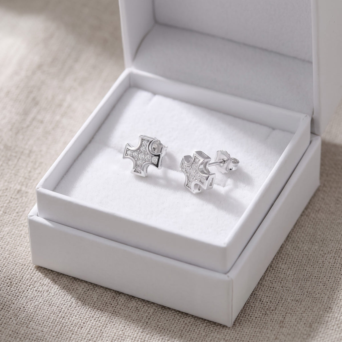 Sterling Silver CZ Iron Cross Stud Earrings in a white gift box, ready to give