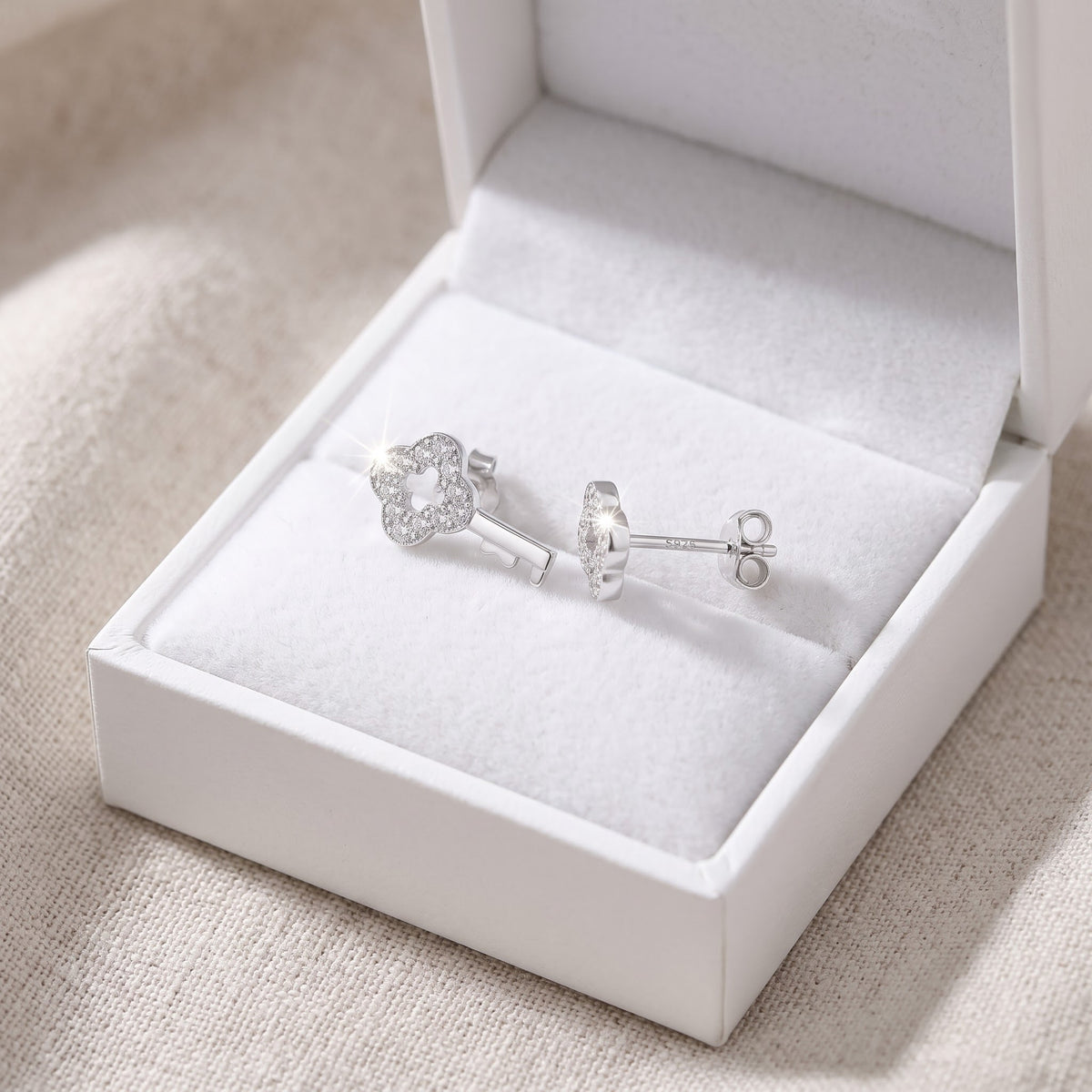 Sterling Silver CZ Key Stud Earrings in a white gift box, ready to give