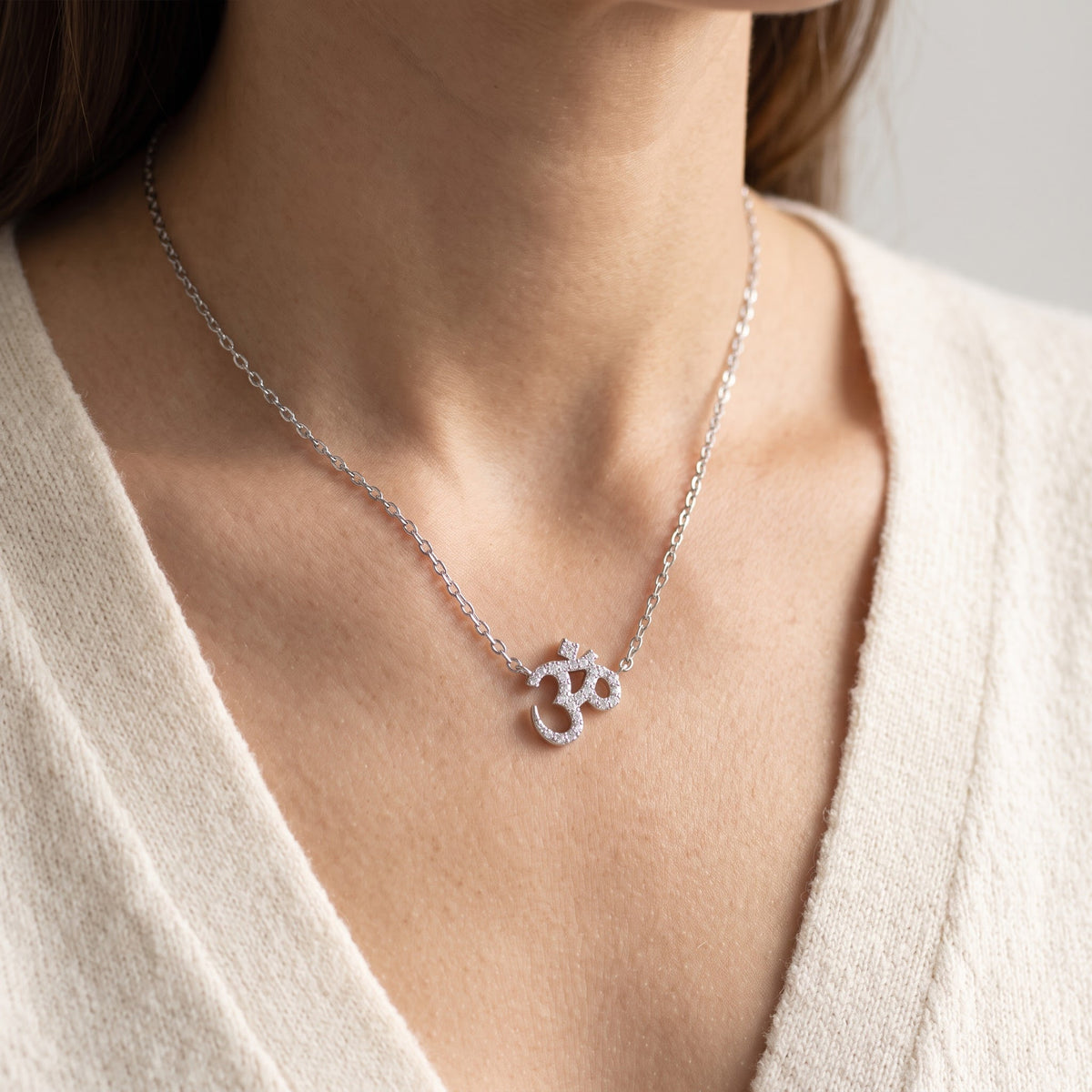 Sterling Silver CZ Om Necklace worn, lifestyle photo