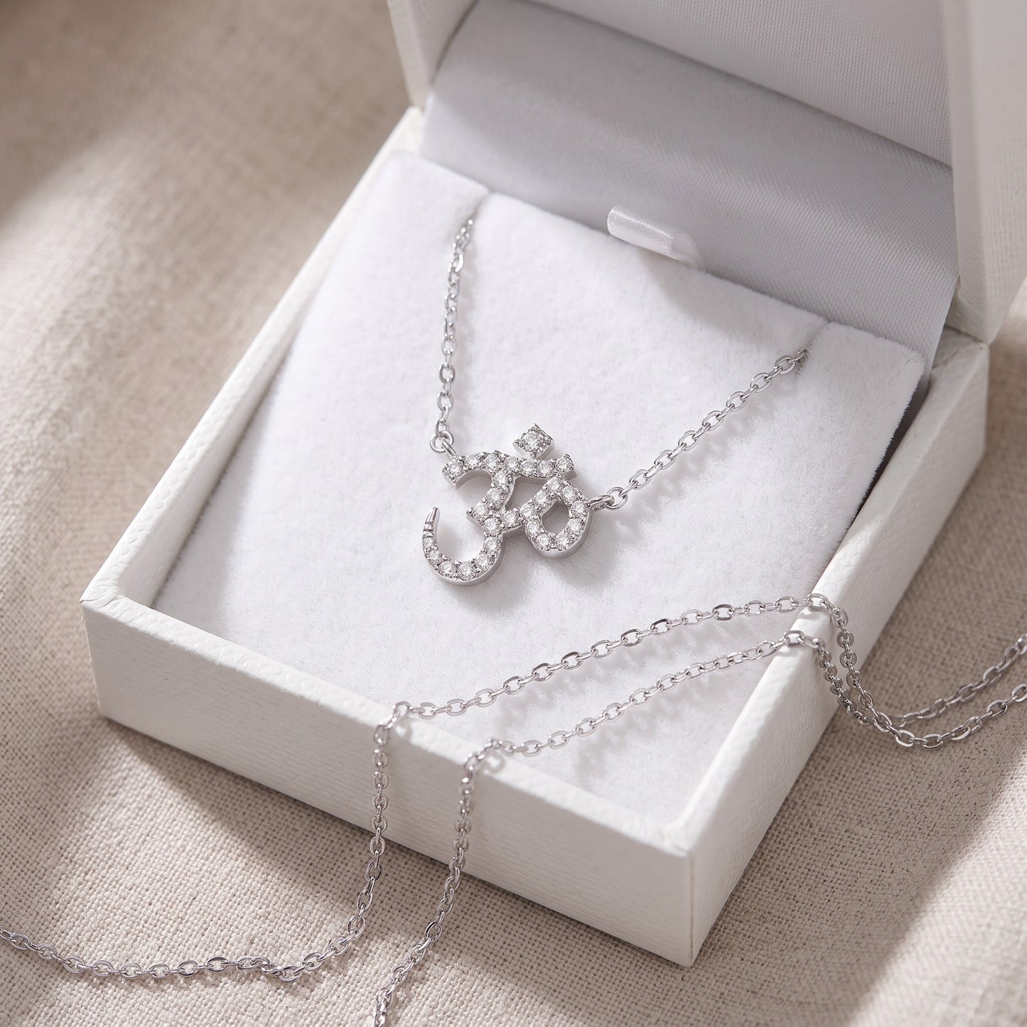 Sterling Silver CZ Om Necklace in a white gift box, ready to give