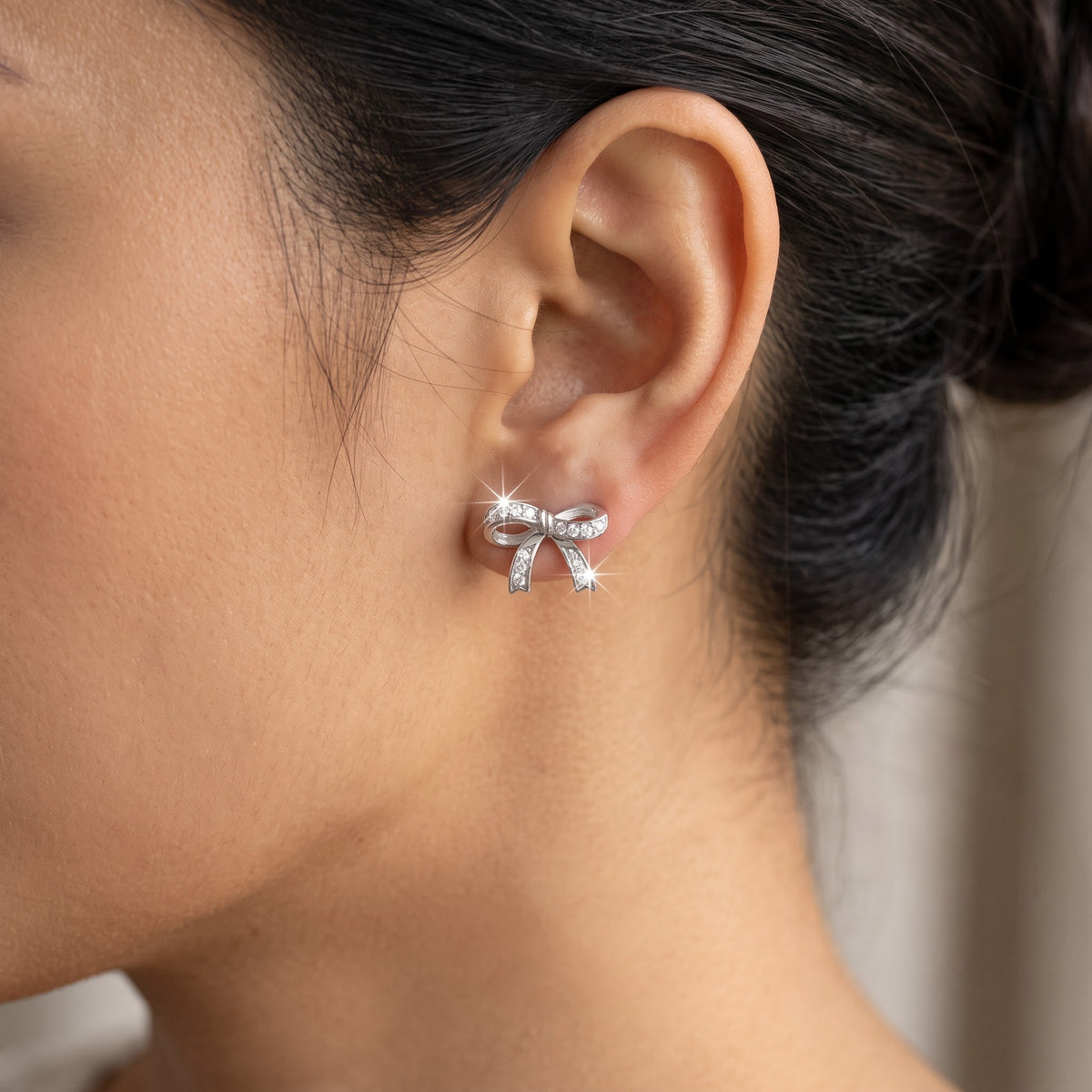 Sterling Silver CZ Ribbon Bow Stud Earrings worn, lifestyle photo