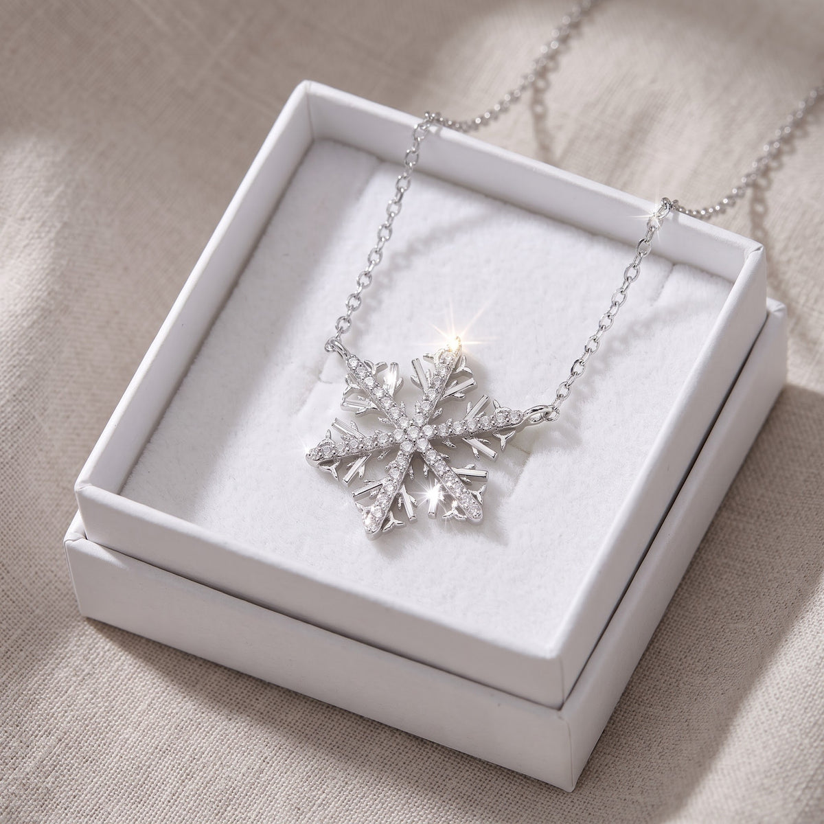 Sterling Silver CZ Snowflake Necklace in a white gift box, ready to give