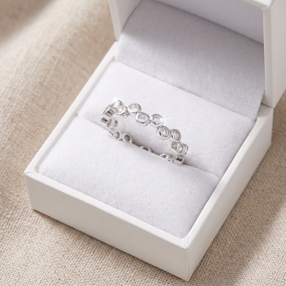 Sterling Silver CZ Stackable Bubbles Eternity Ring in a white gift box, ready to give
