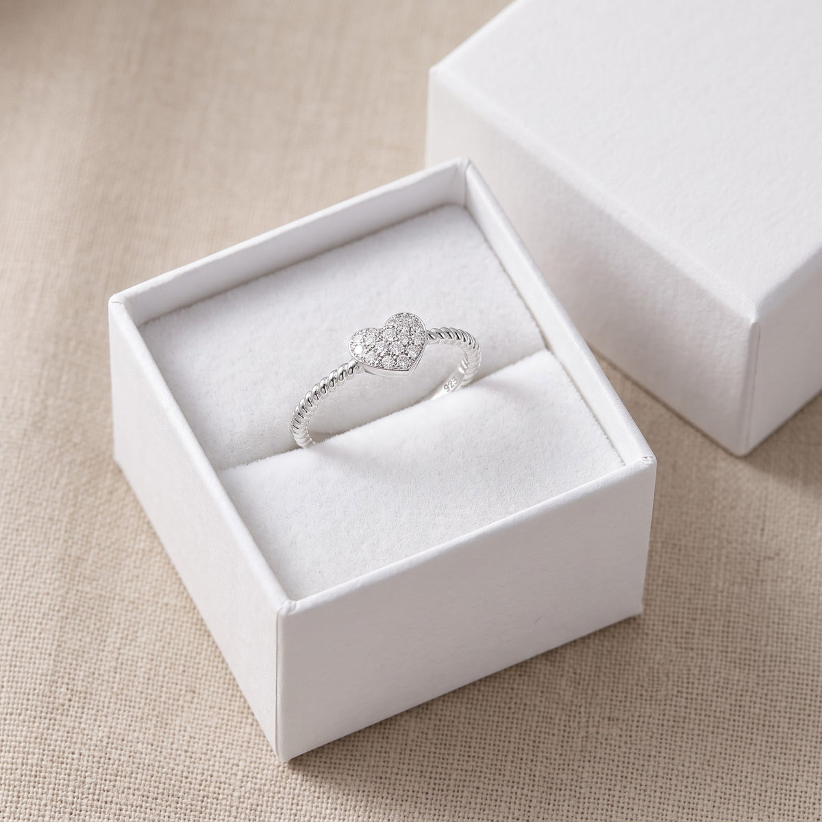 Sterling Silver CZ Stackable Rope Heart Ring in a white gift box, ready to give