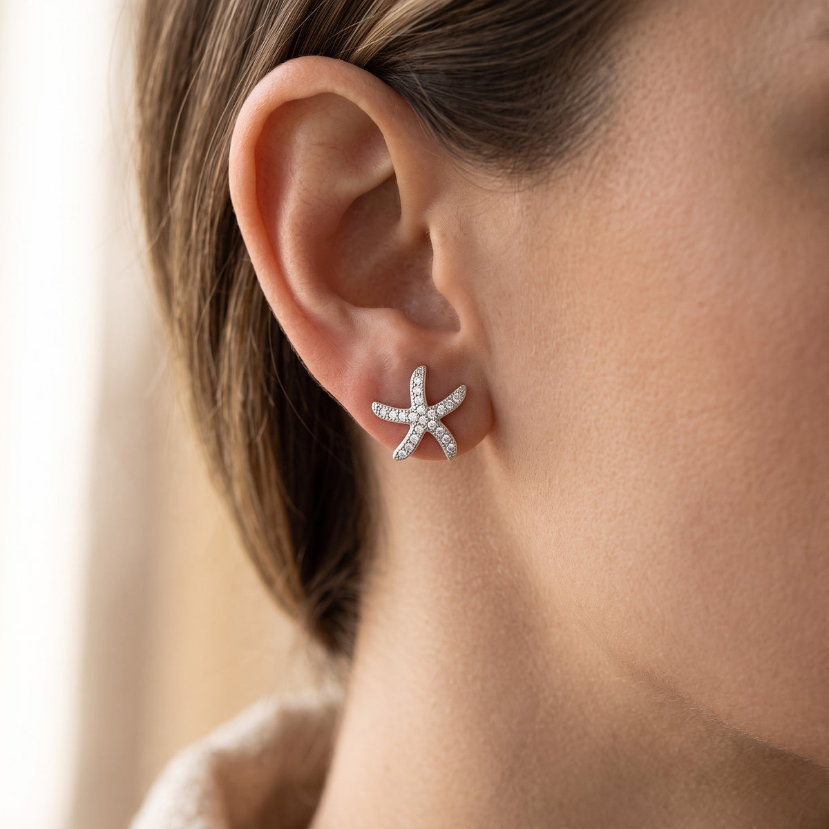 Sterling Silver CZ Starfish Stud Earrings worn, lifestyle photo