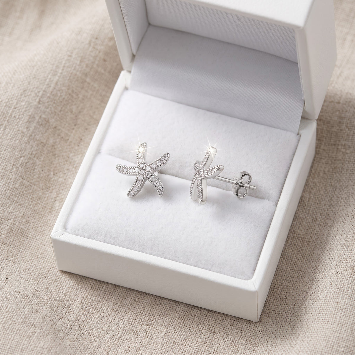 Sterling Silver CZ Starfish Stud Earrings in a white gift box, ready to give