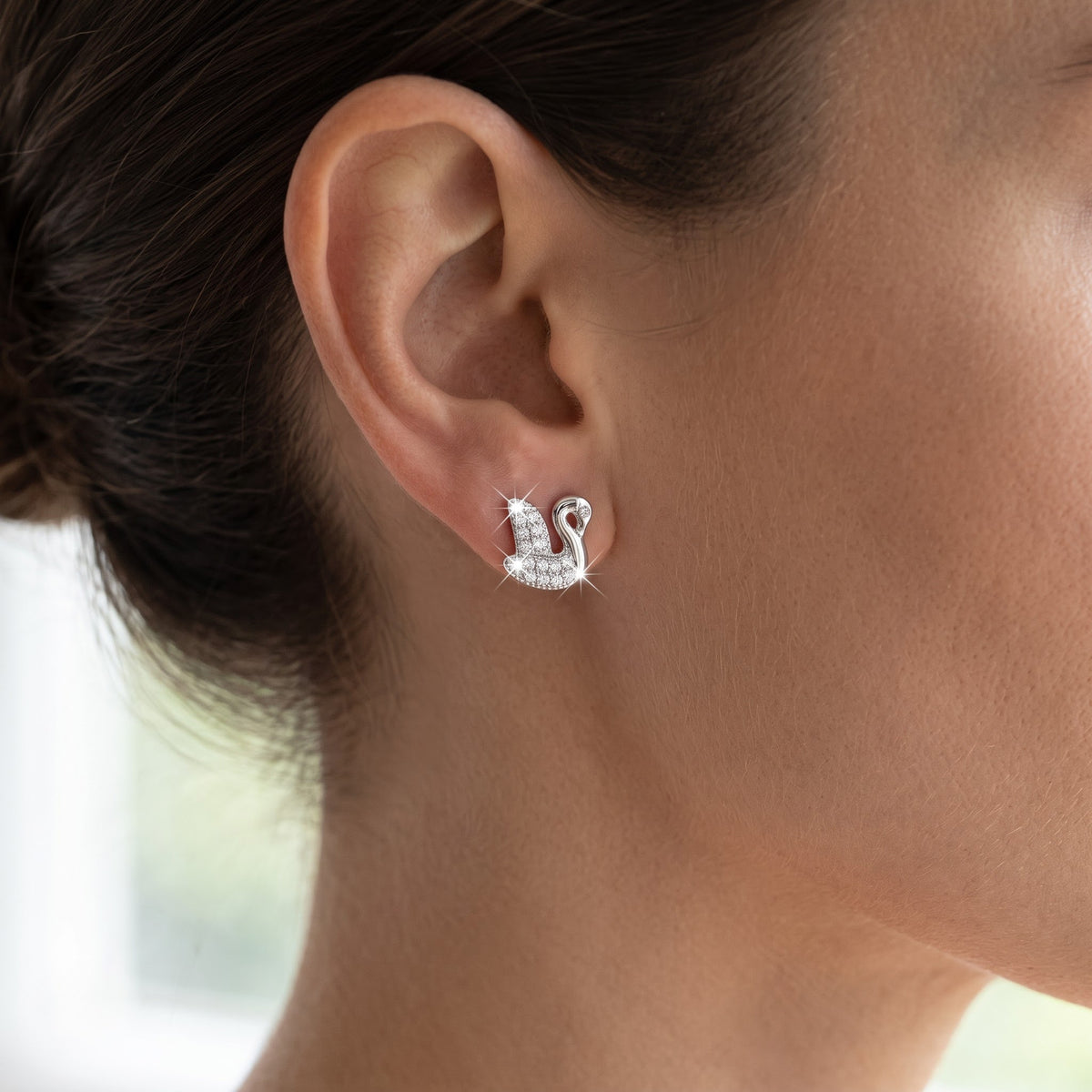 Sterling Silver CZ Swan Stud Earrings worn, lifestyle photo