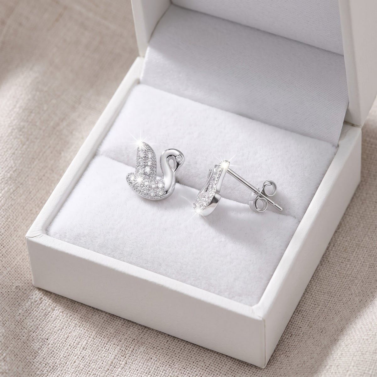 Sterling Silver CZ Swan Stud Earrings in a white gift box, ready to give