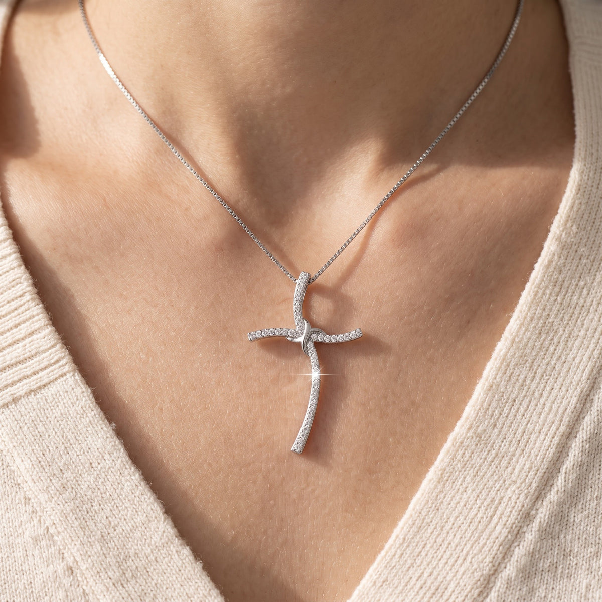 Sterling Silver CZ Thin Wavy Cross Necklace, 18" worn, lifestyle photo