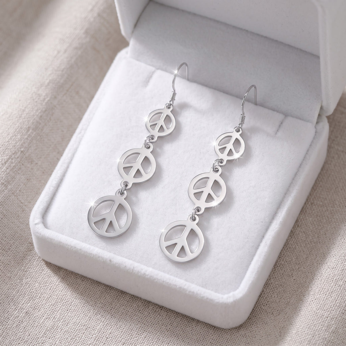 Sterling Silver Dangling Peace Sign Earrings in a white gift box, ready to give