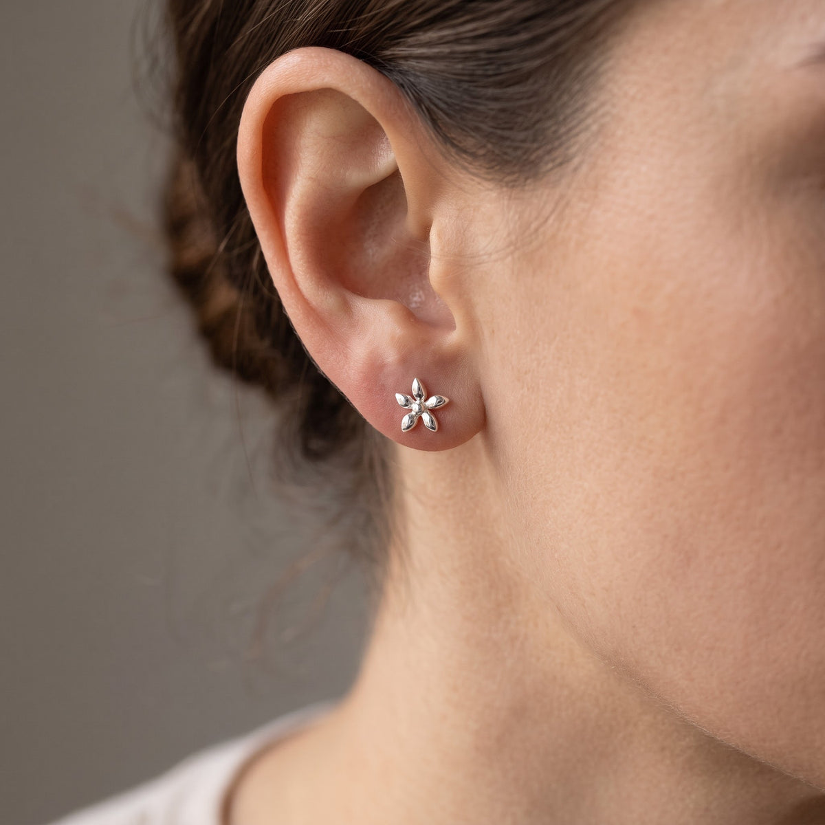 Sterling Silver Girls Tiny Star Flower Stud Earrings worn, lifestyle photo