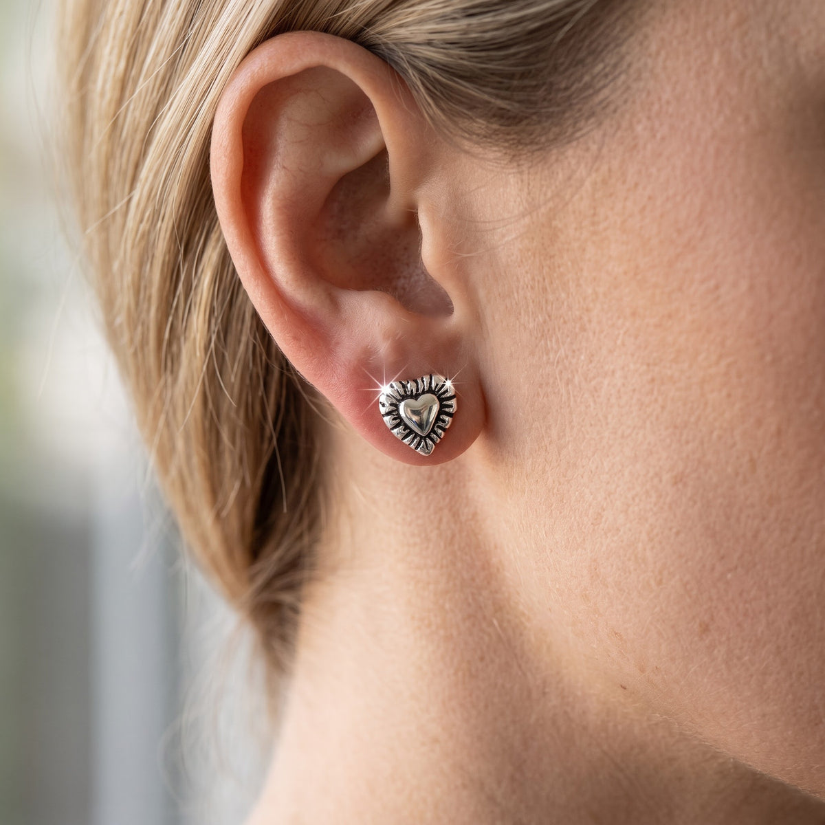 Sterling Silver Heart Stud Earrings - 7mm worn, lifestyle photo
