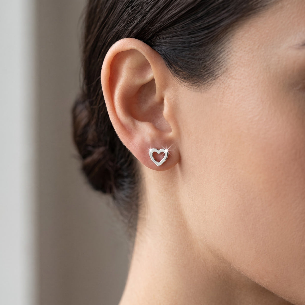 Sterling Silver Hollow Heart Stud Earrings, 4mm worn, lifestyle photo