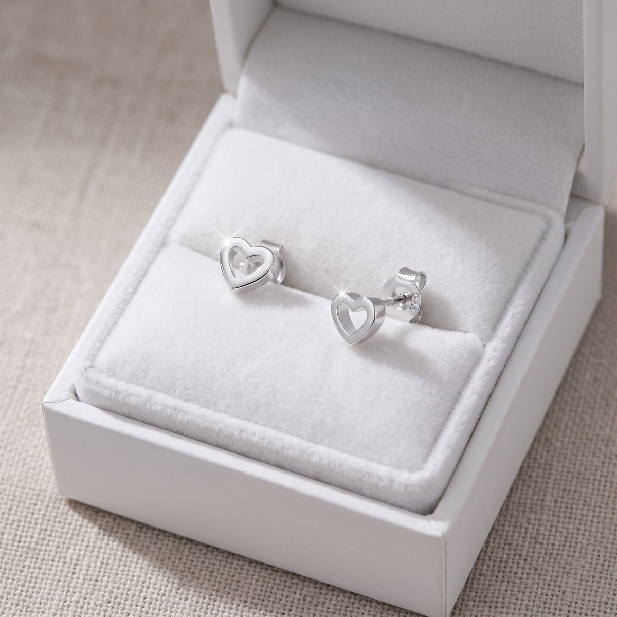 Sterling Silver Hollow Heart Stud Earrings, 4mm in a white gift box, ready to give