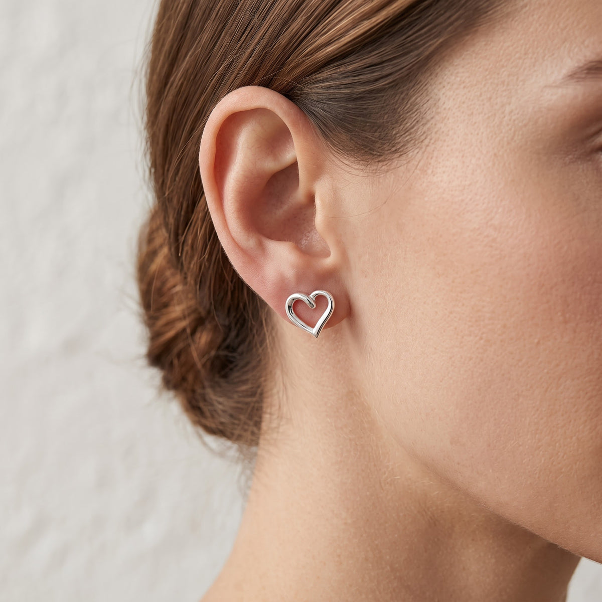 Sterling Silver Ladies Dainty Hollow Heart Stud Earrings, 8mm worn, lifestyle photo