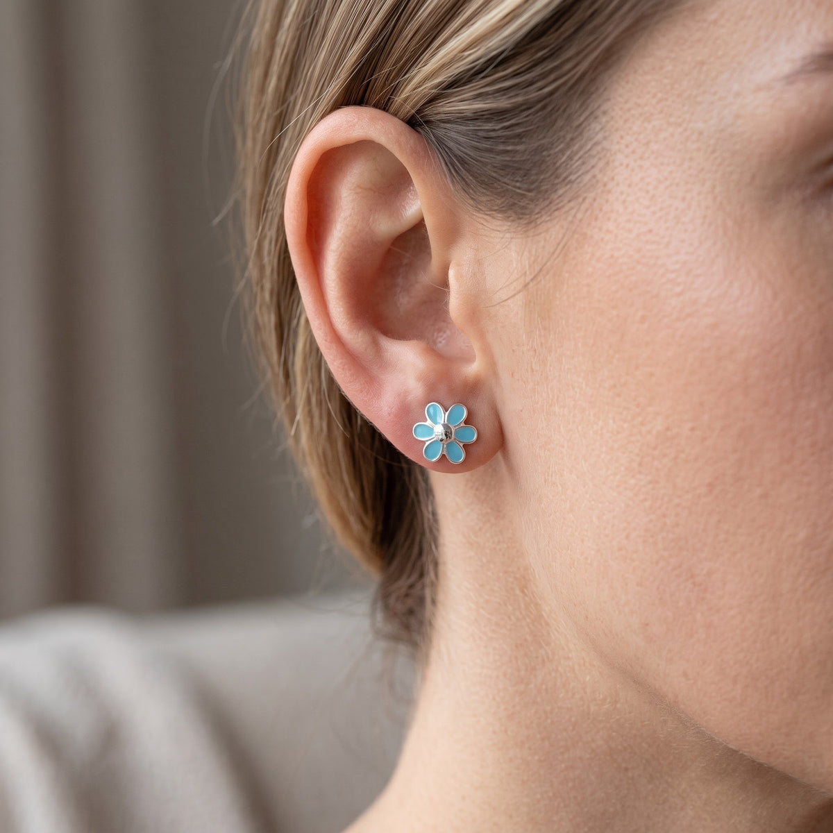 Sterling Silver Girls Dainty Light Blue Daisy Flower Stud Earrings worn, lifestyle photo