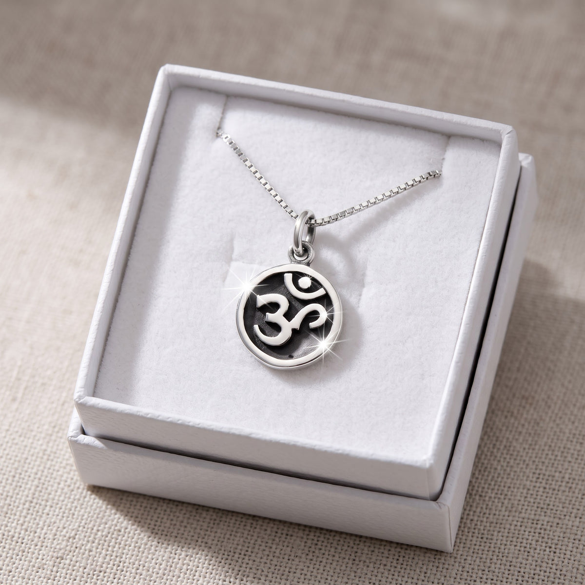 Sterling Silver Om Sign Necklace in a white gift box, ready to give
