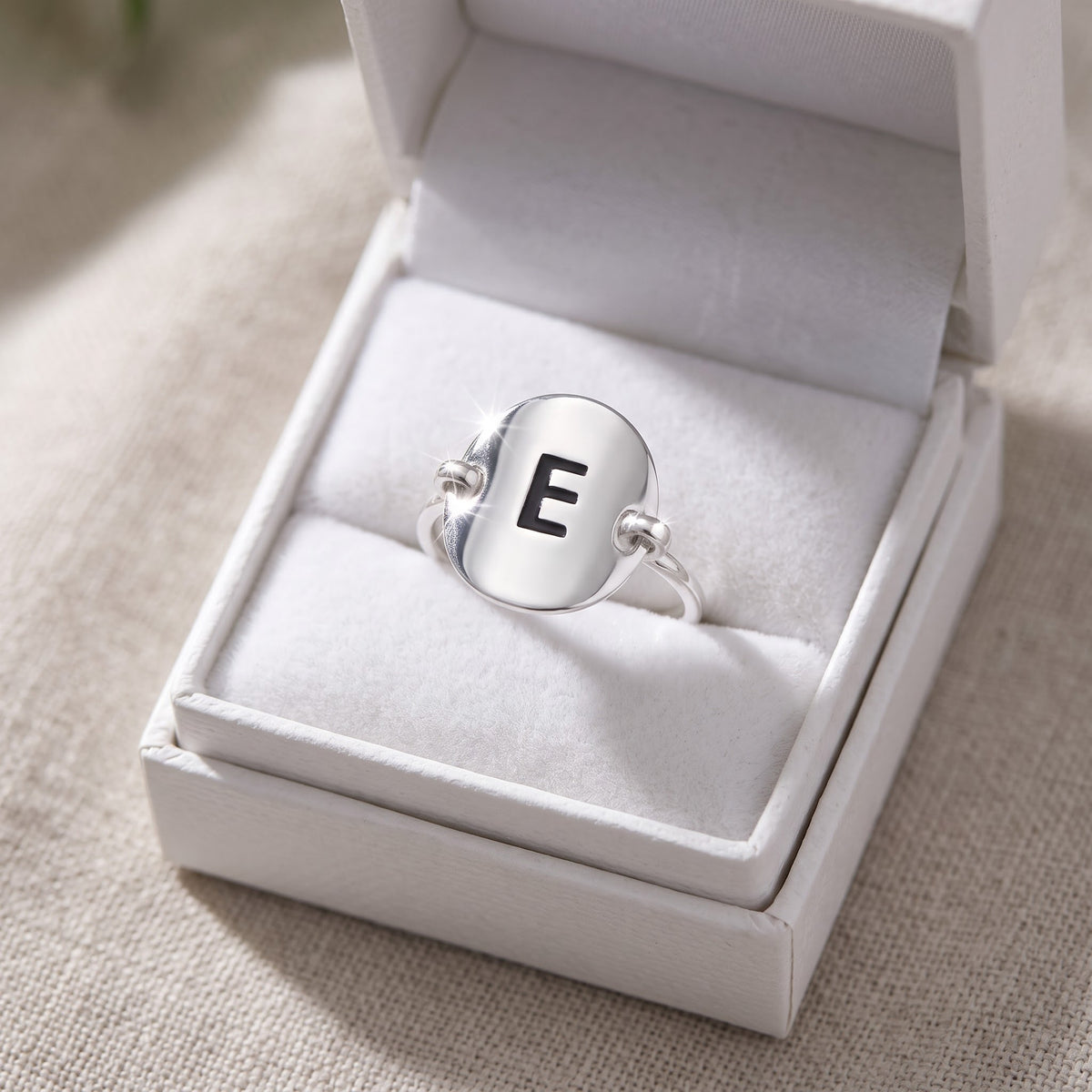 Sterling Silver Oval Initial E Ring in a white gift box, ready to give