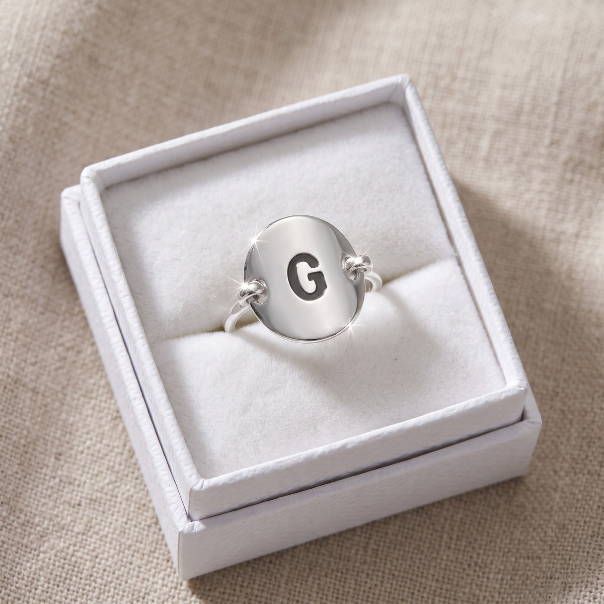 Sterling Silver Oval Initial G Ring in a white gift box, ready to give