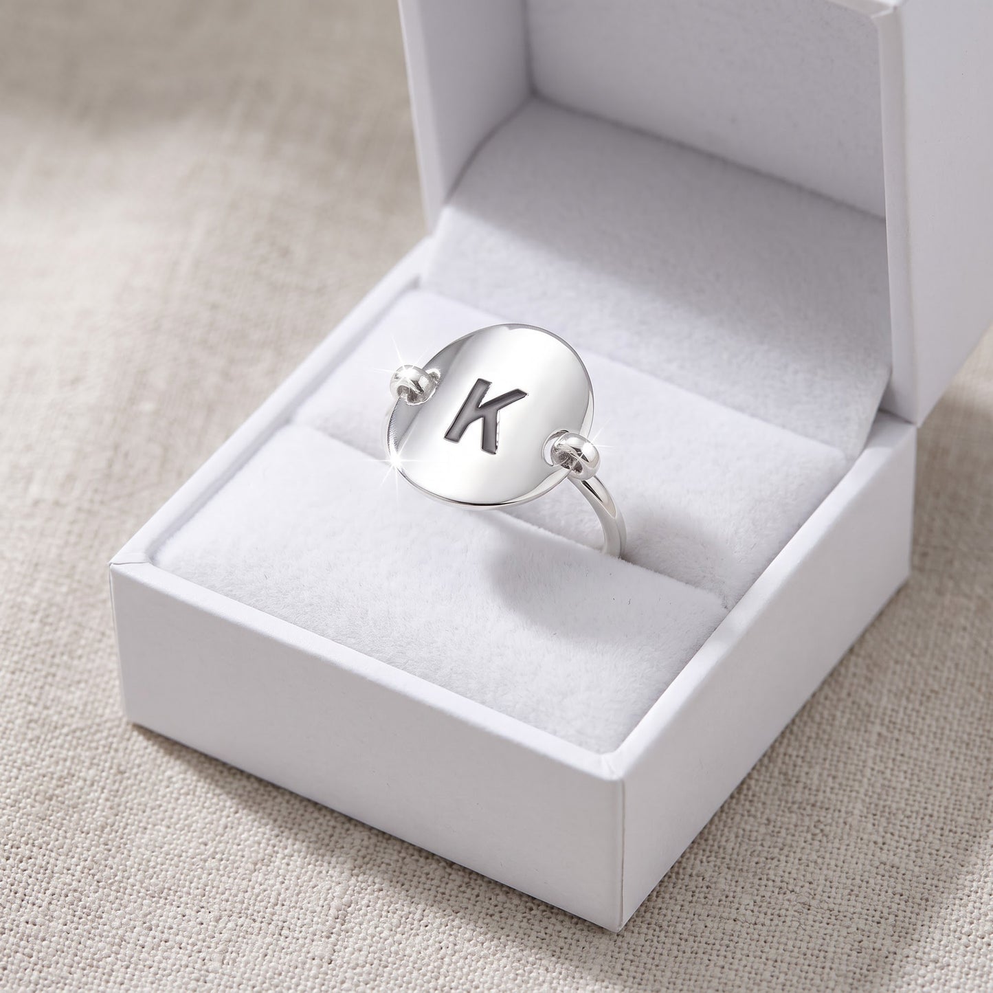 Sterling Silver Oval Initial K Ring in a white gift box, ready to give