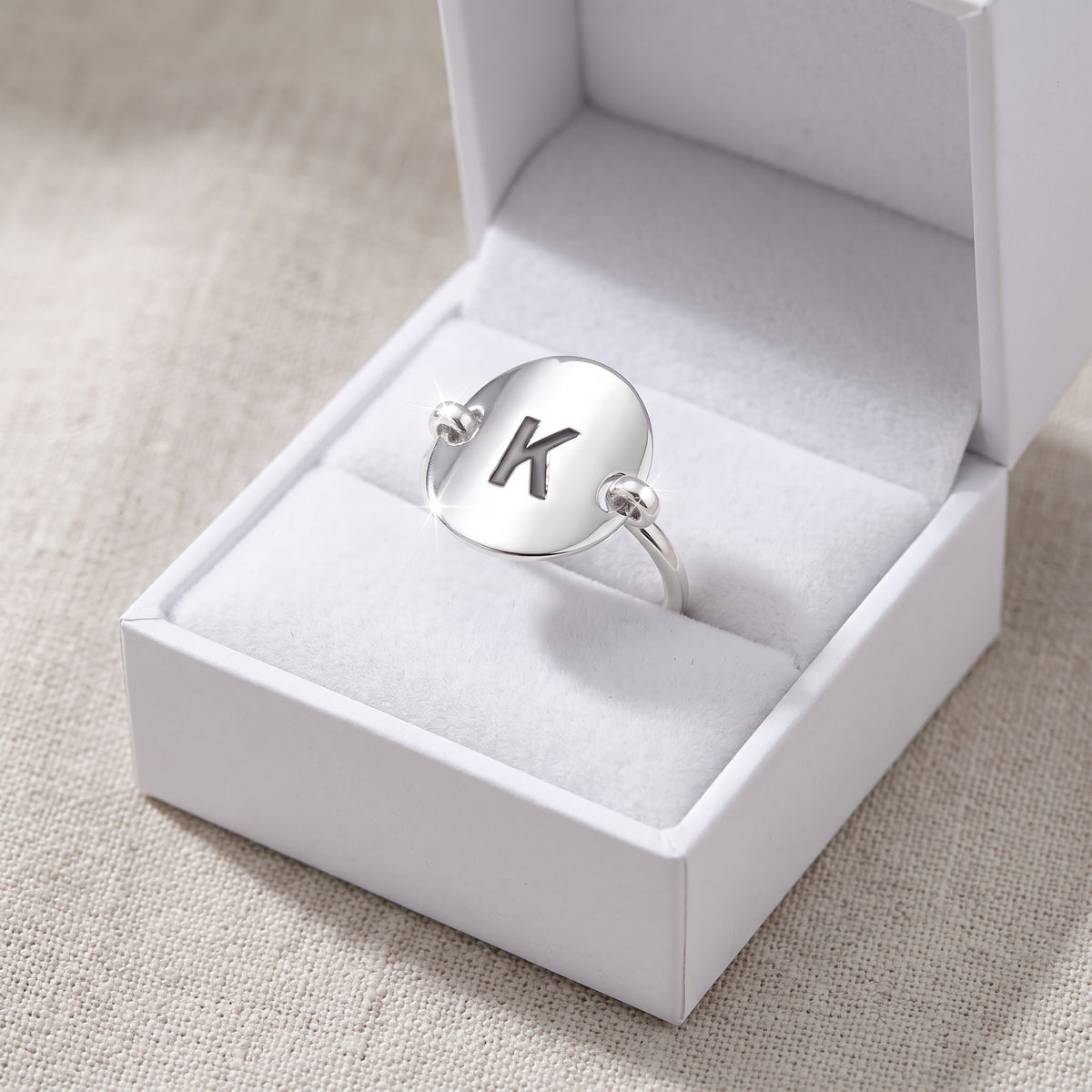 Sterling Silver Oval Initial K Ring in a white gift box, ready to give