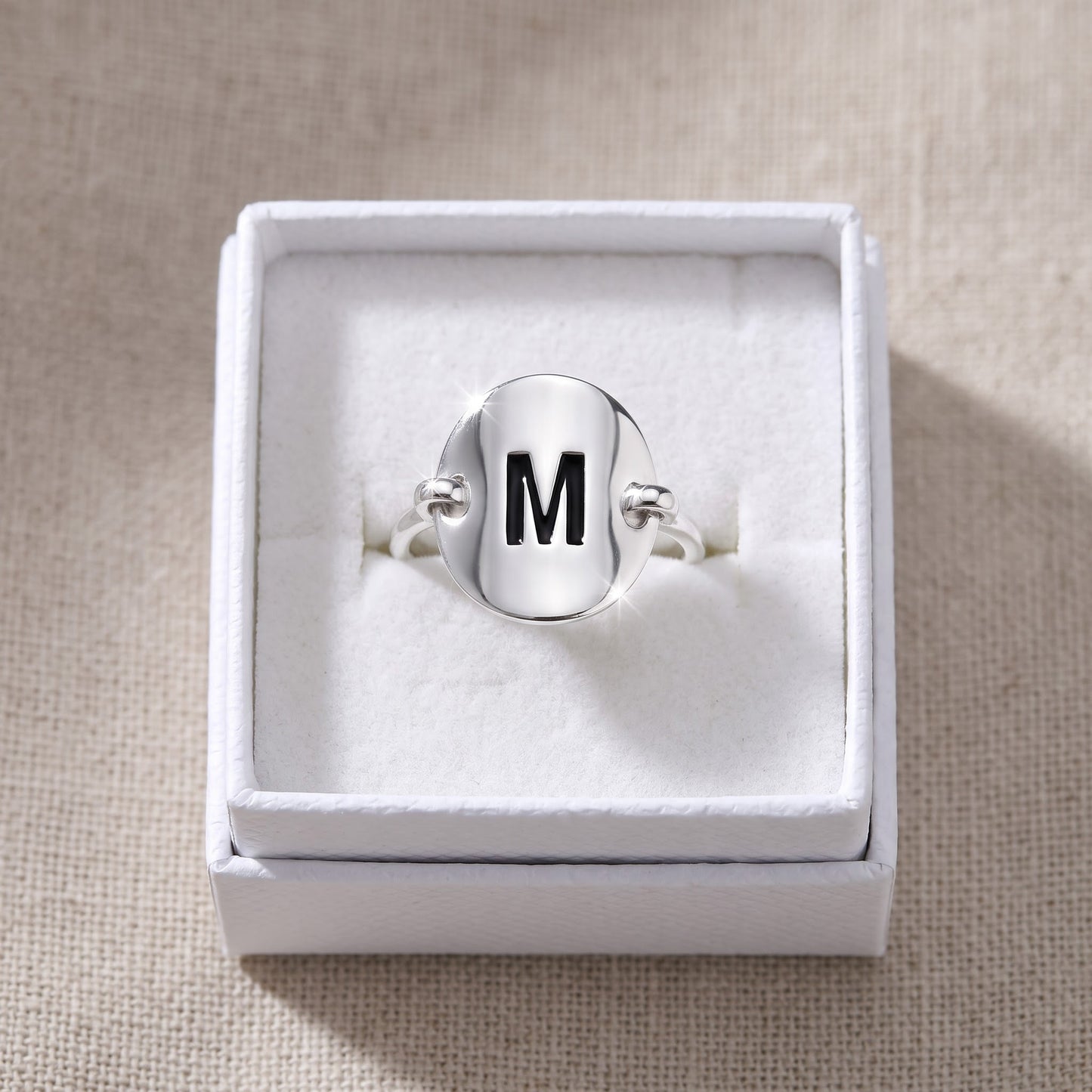 Sterling Silver Oval Initial M Ring in a white gift box, ready to give