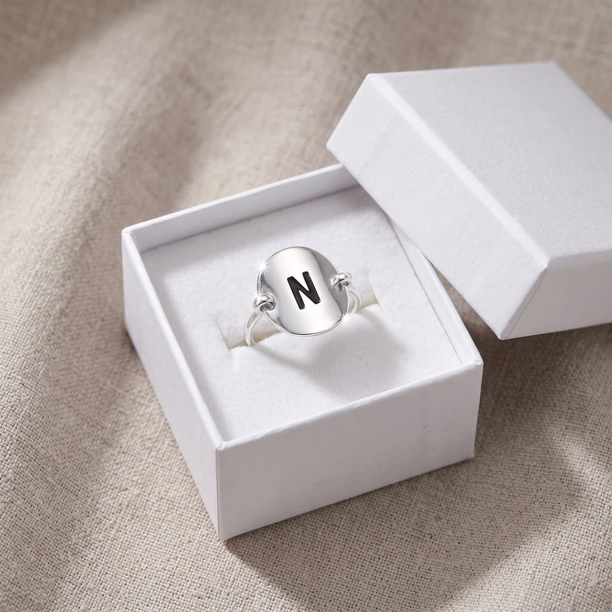 Sterling Silver Oval Initial N Ring in a white gift box, ready to give