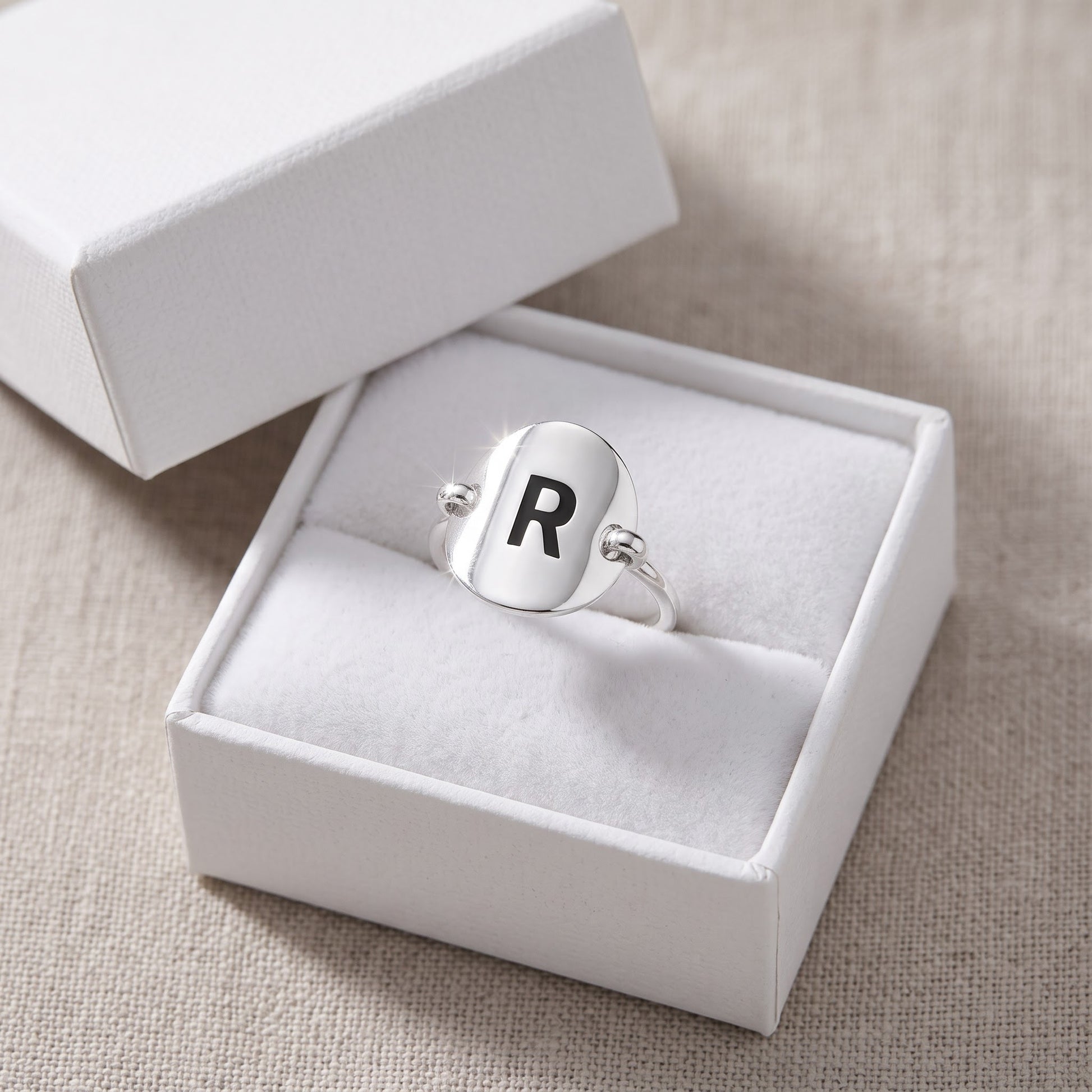 Sterling Silver Oval Initial R Ring in a white gift box, ready to give