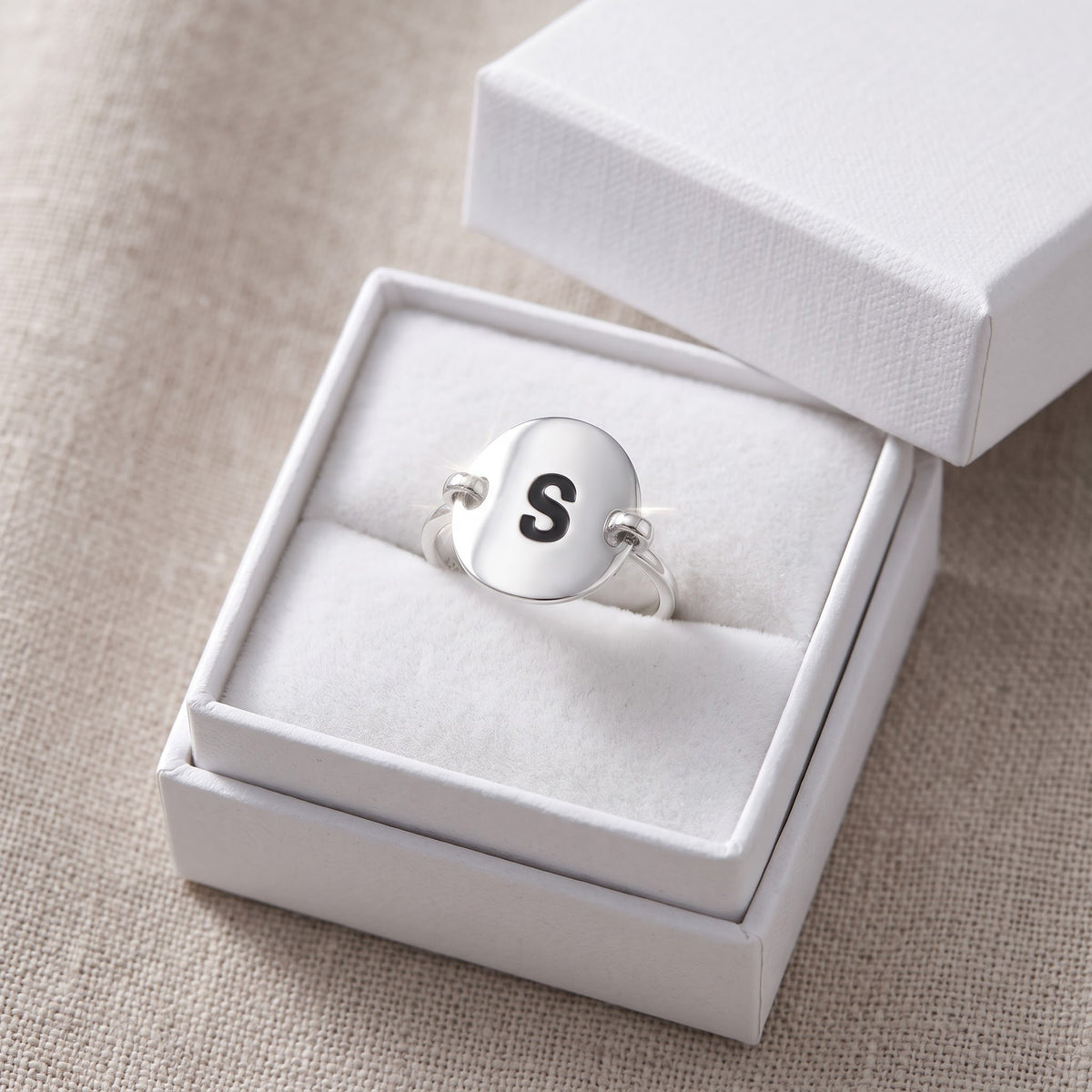 Sterling Silver Oval Initial S Ring in a white gift box, ready to give