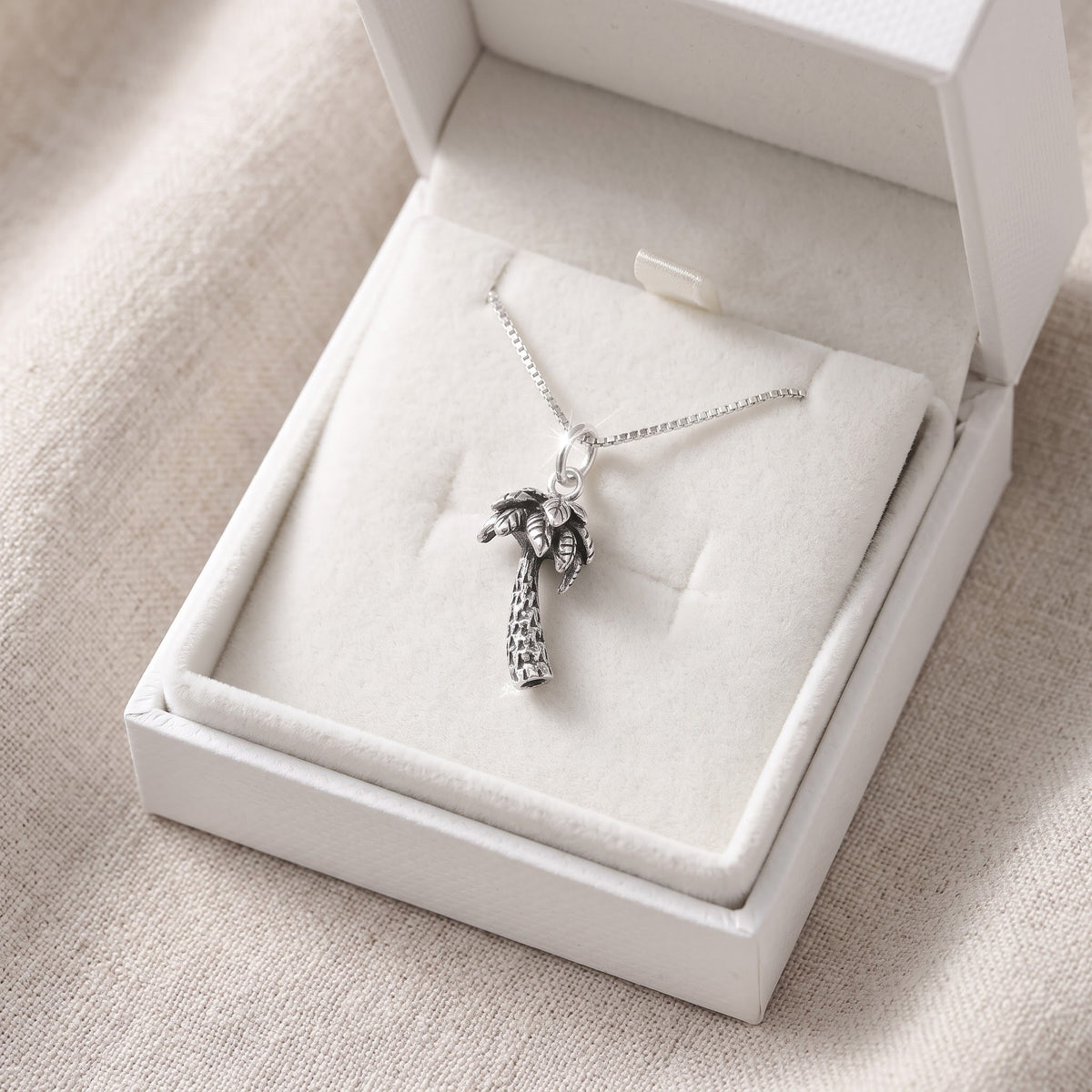 Sterling Silver Palm Tree Necklace in a white gift box, ready to give