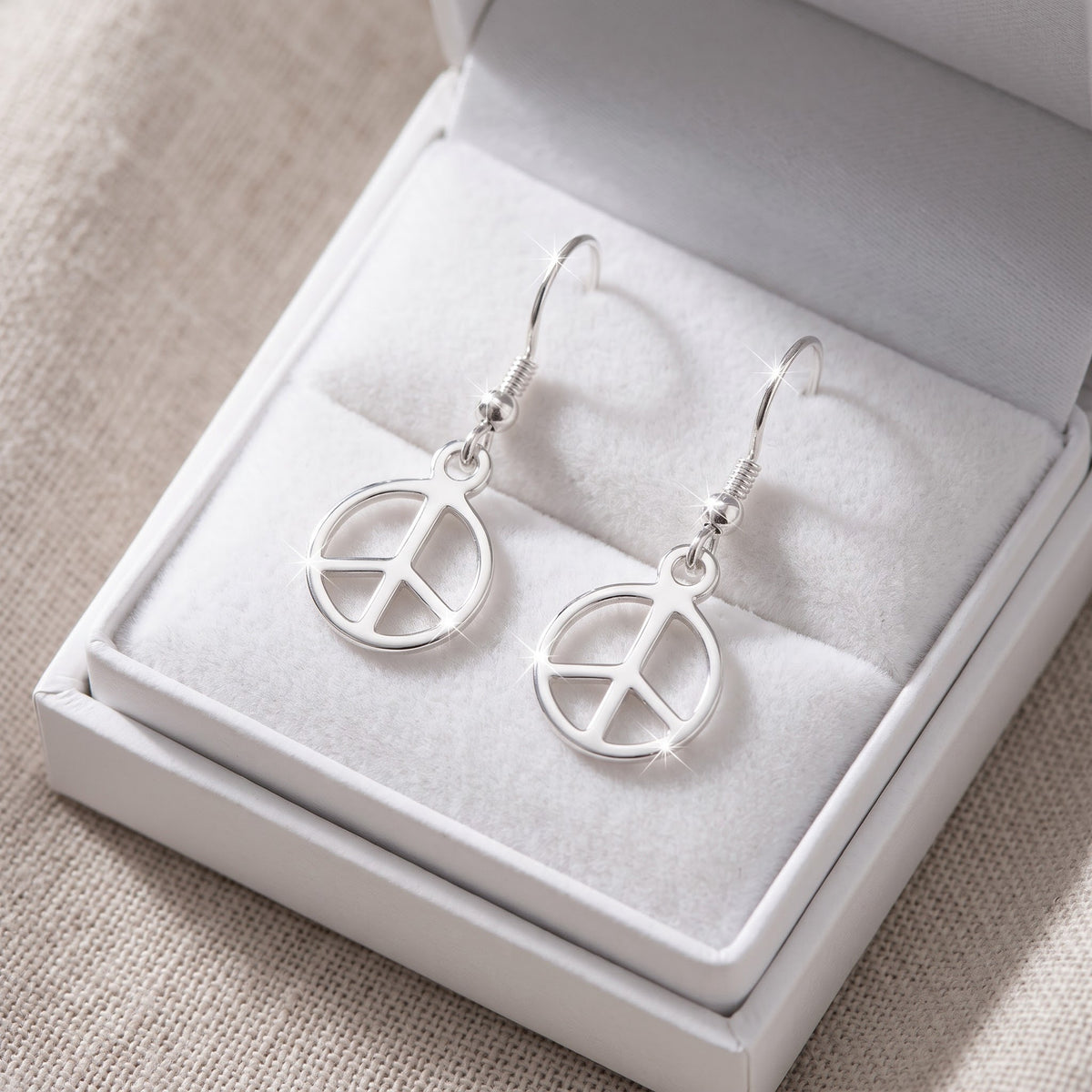 Sterling Silver Grils Dainty Peace Sign Dangle Earrings in a white gift box, ready to give