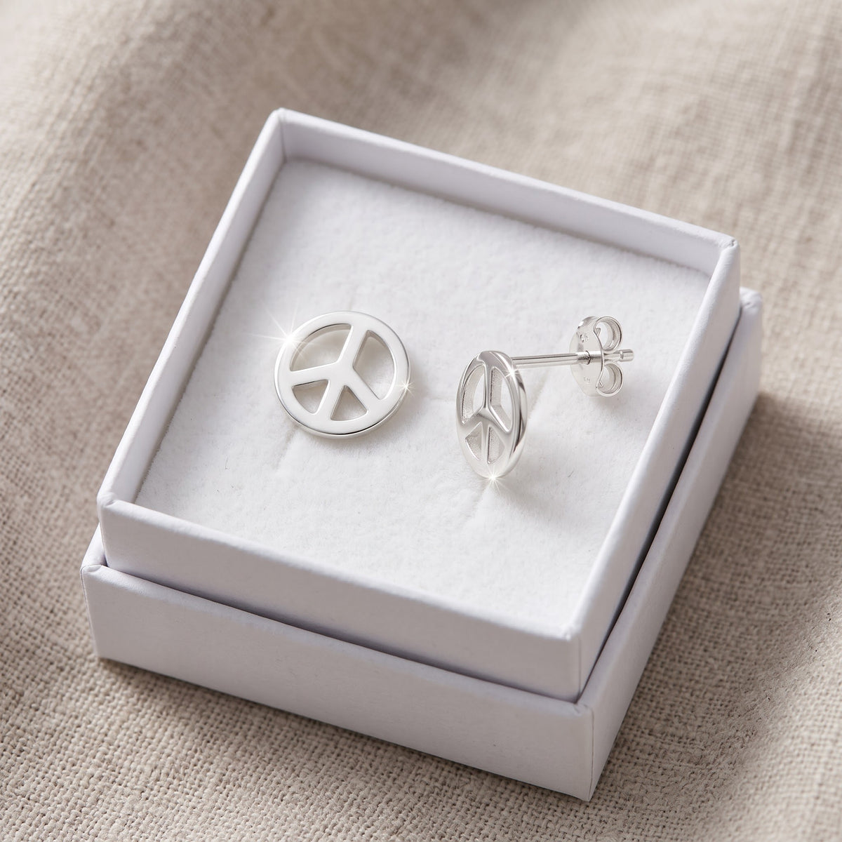 Sterling Silver Dainty Peace Sign stud Earrings in a white gift box, ready to give