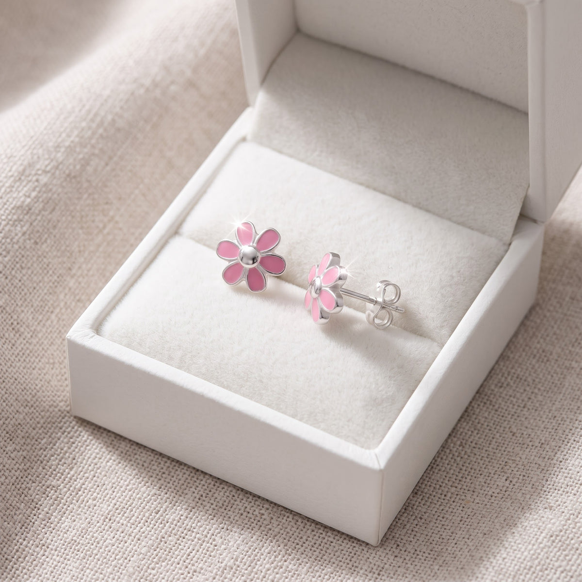 Sterling Silver Dainty Women's Pink Daisy Flower Stud Earrings in a white gift box, ready to give
